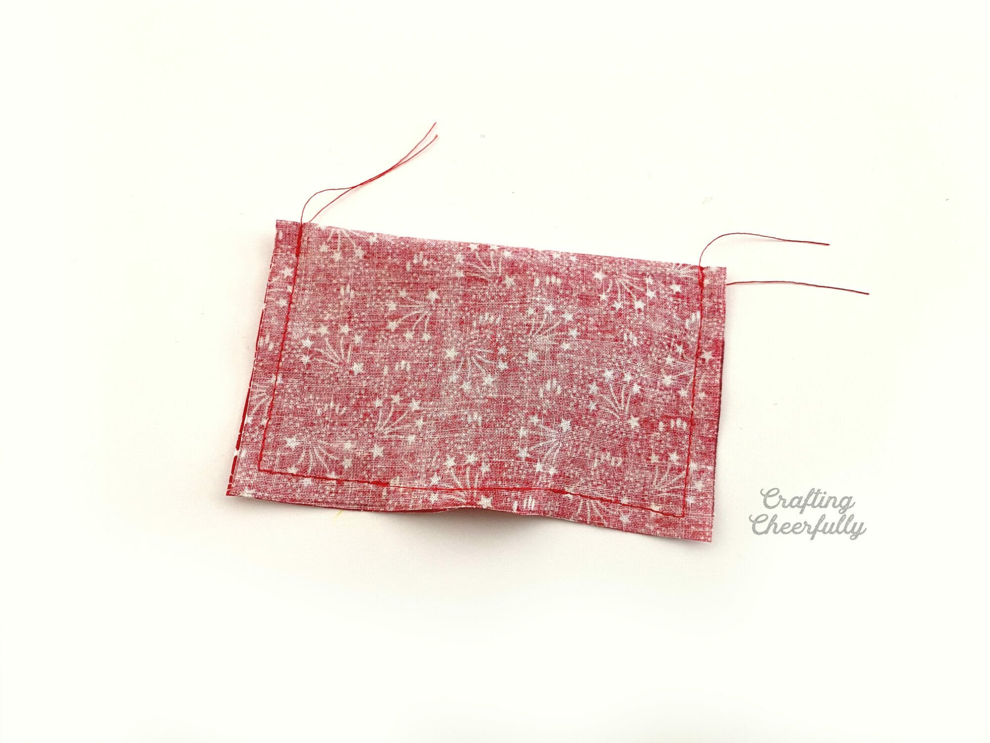 Red pillow wreath folded in half and stitched around the edges.
