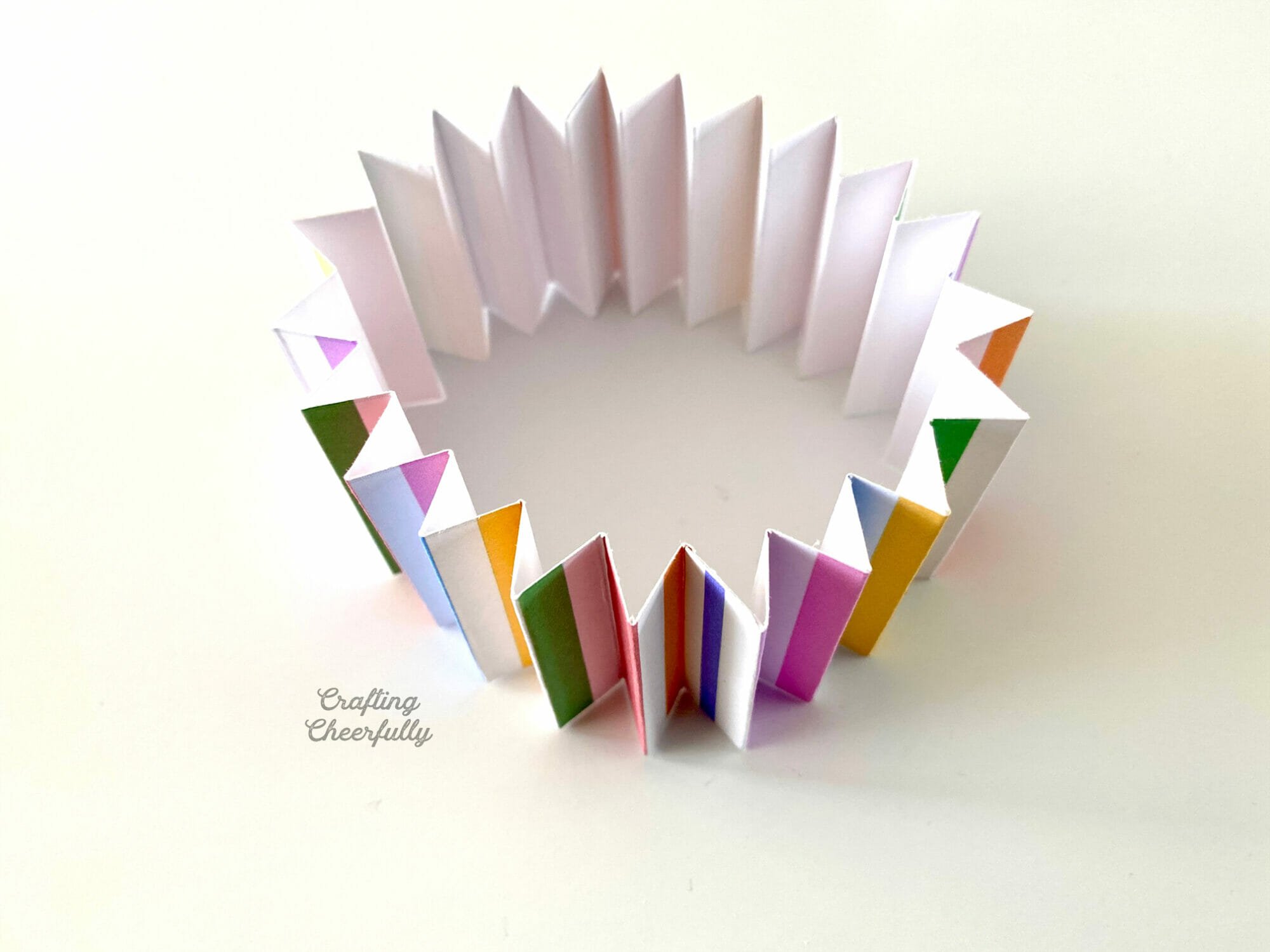 Piece of accordion-folded paper connected in a circle.