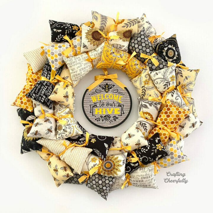 Welcome Bee Wreath on a white surface.