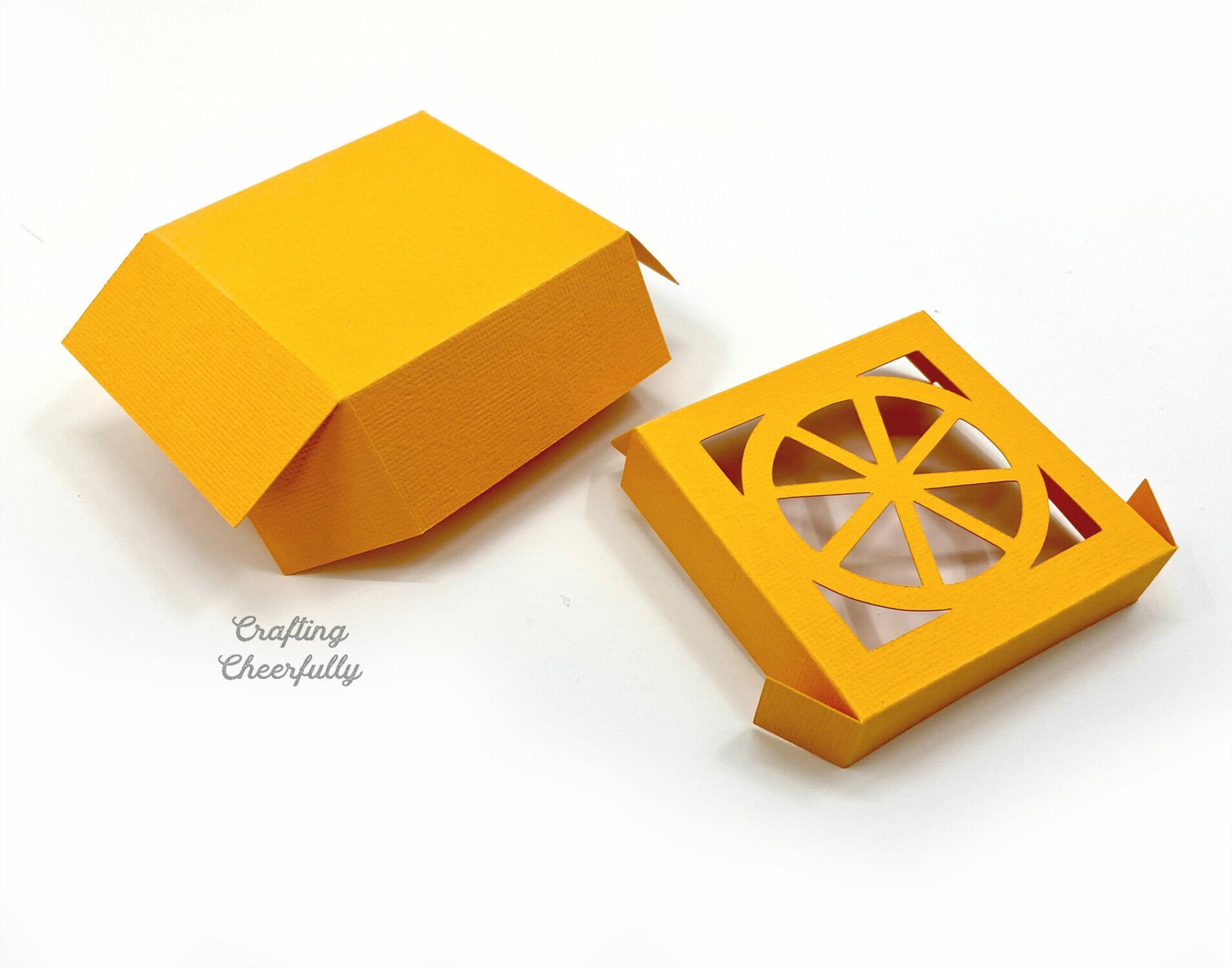 Orange fruit box folded and ready to be taped together.