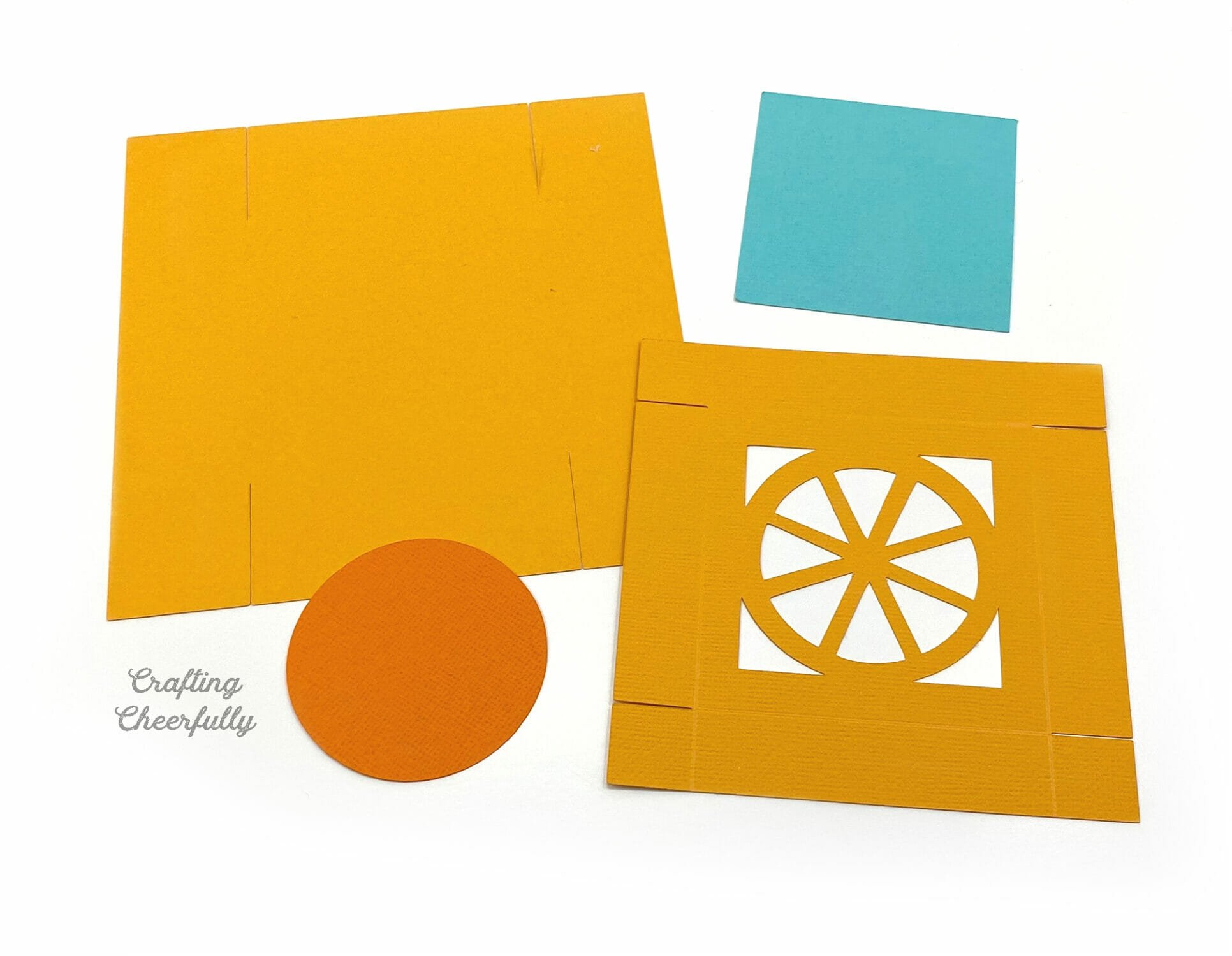 Cut pieces of paper to make an orange fruit box