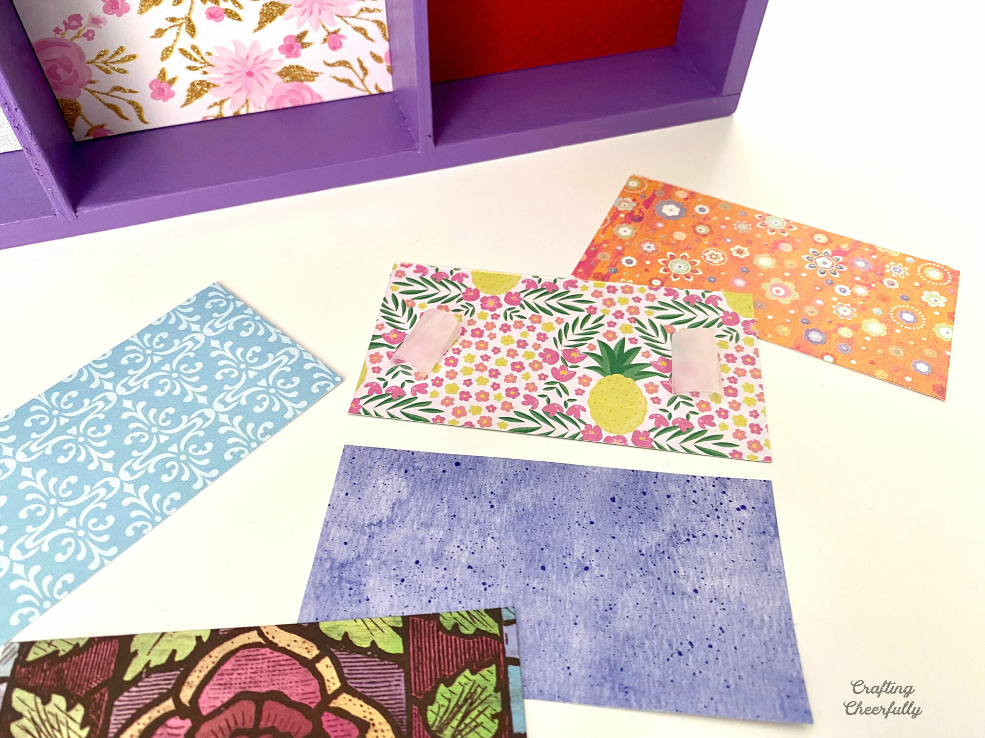 Rectangular pieces of patterned scrapbook paper.