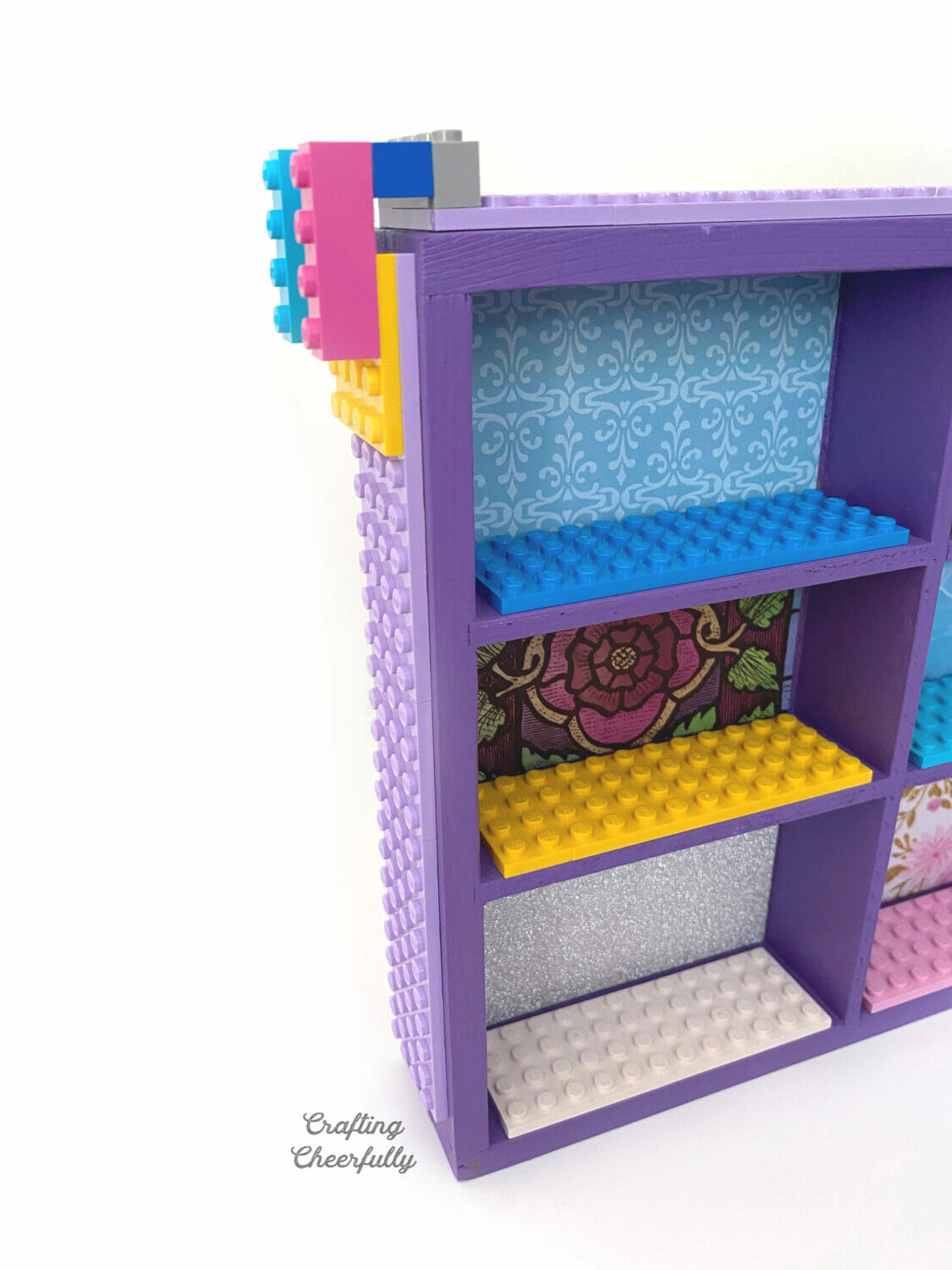LEGOs are added to the sides of the wooden case.