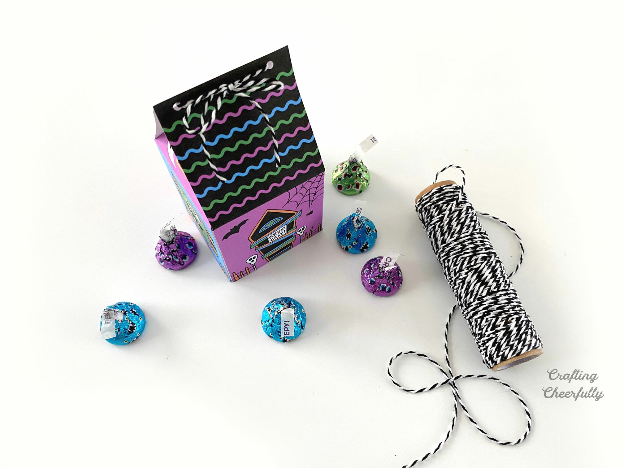 Haunted House Monster treat box sits next to a roll of Baker's twine and candy.
