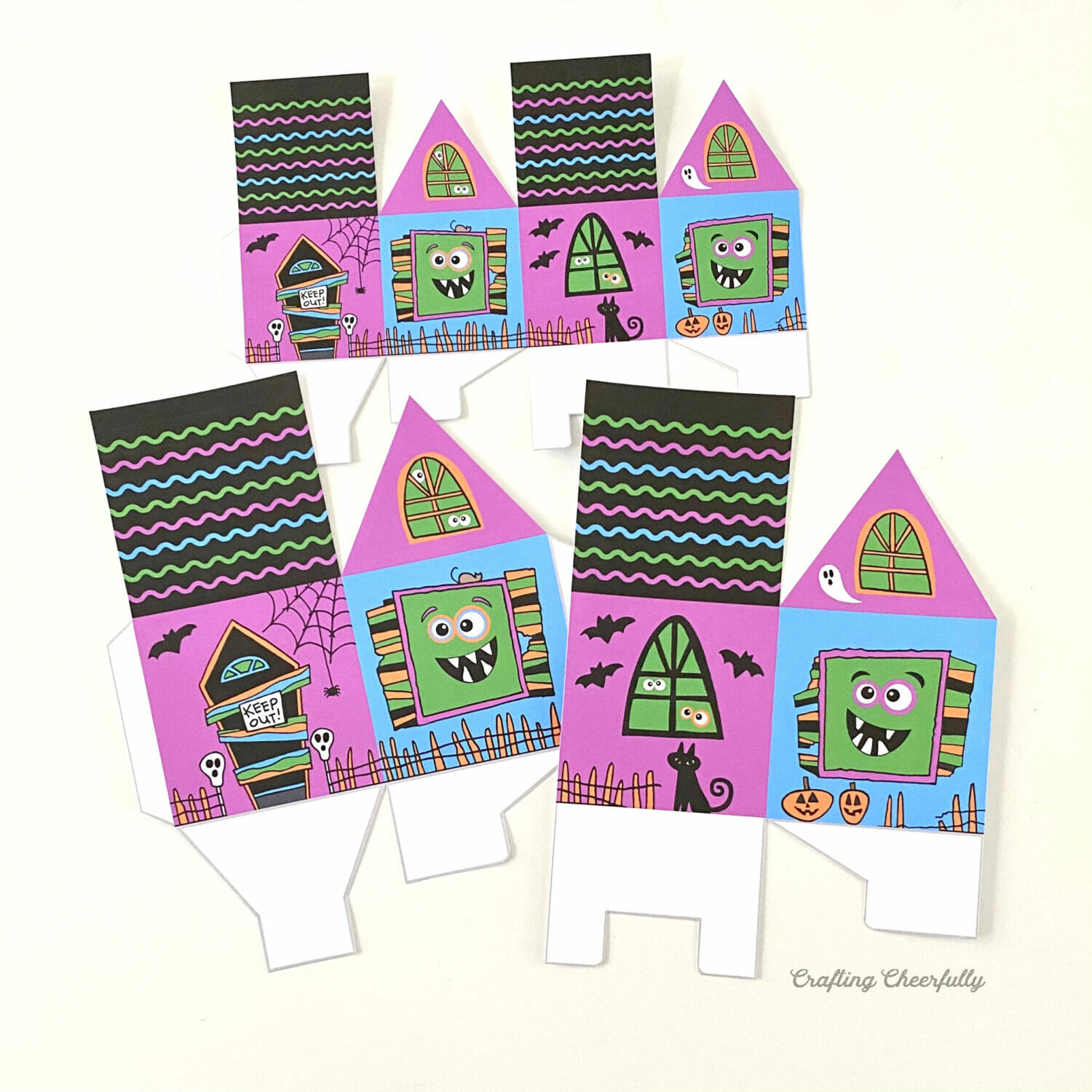 Cut out monster treat box printables on a white table.