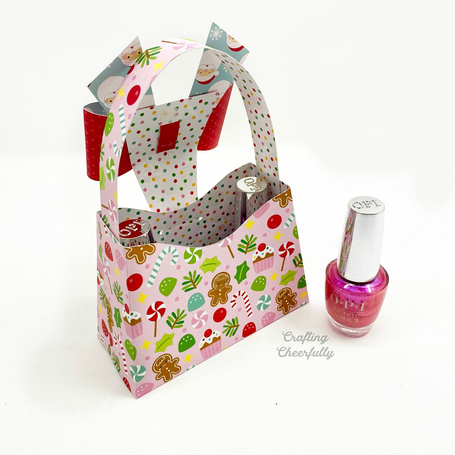 A paper purse is open showing two nail polish bottles sitting inside.
