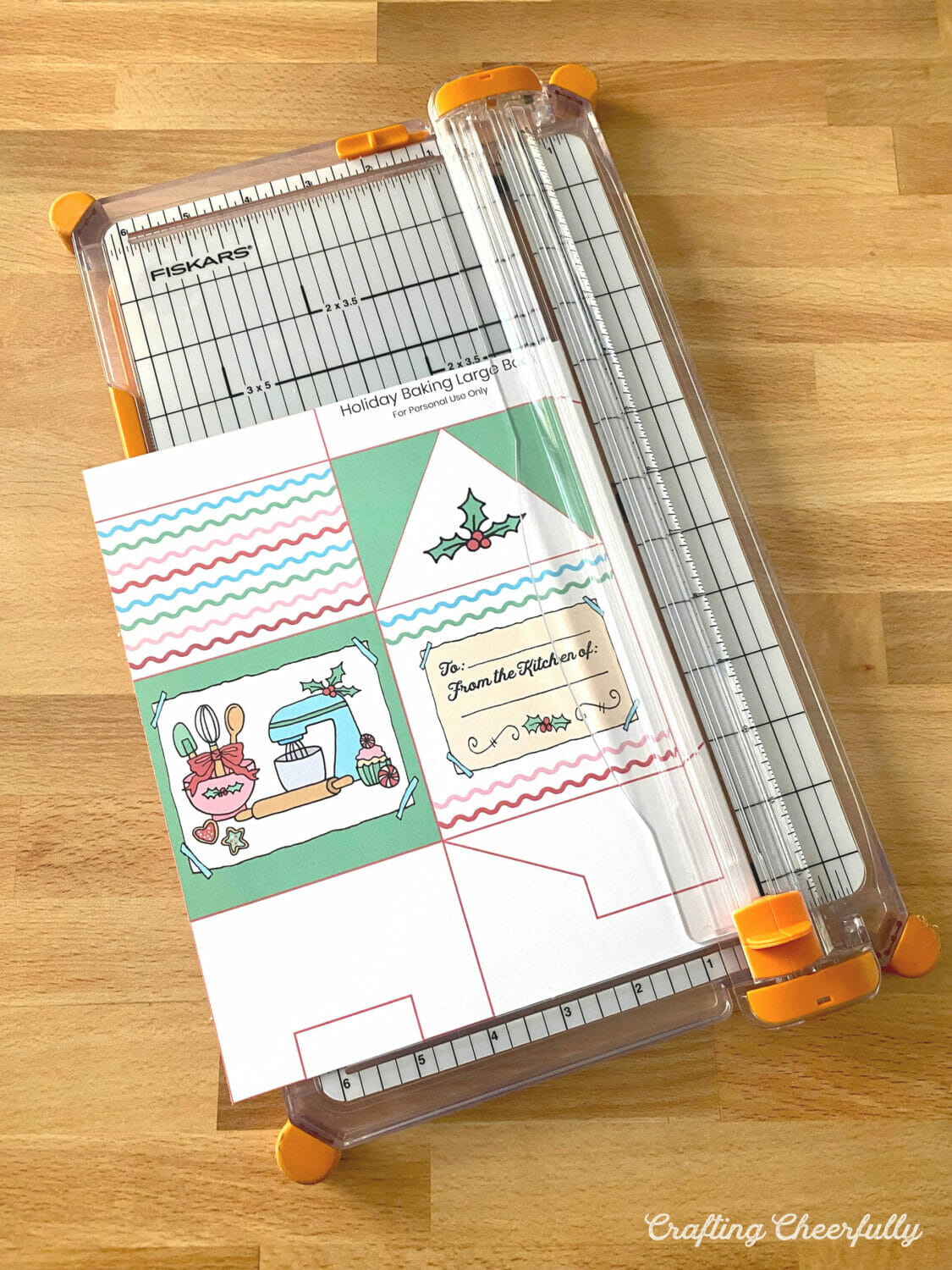A holiday treat box is cut out using a paper trimmer.