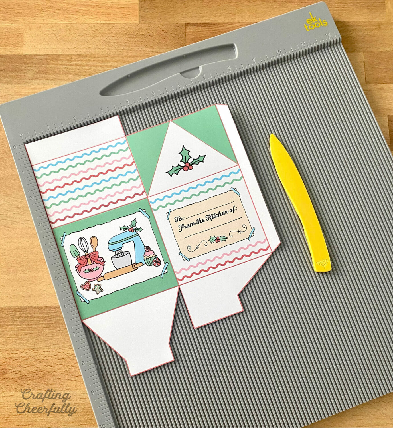 a cookie treat box lays on a scoring board next to a yellow stylus.