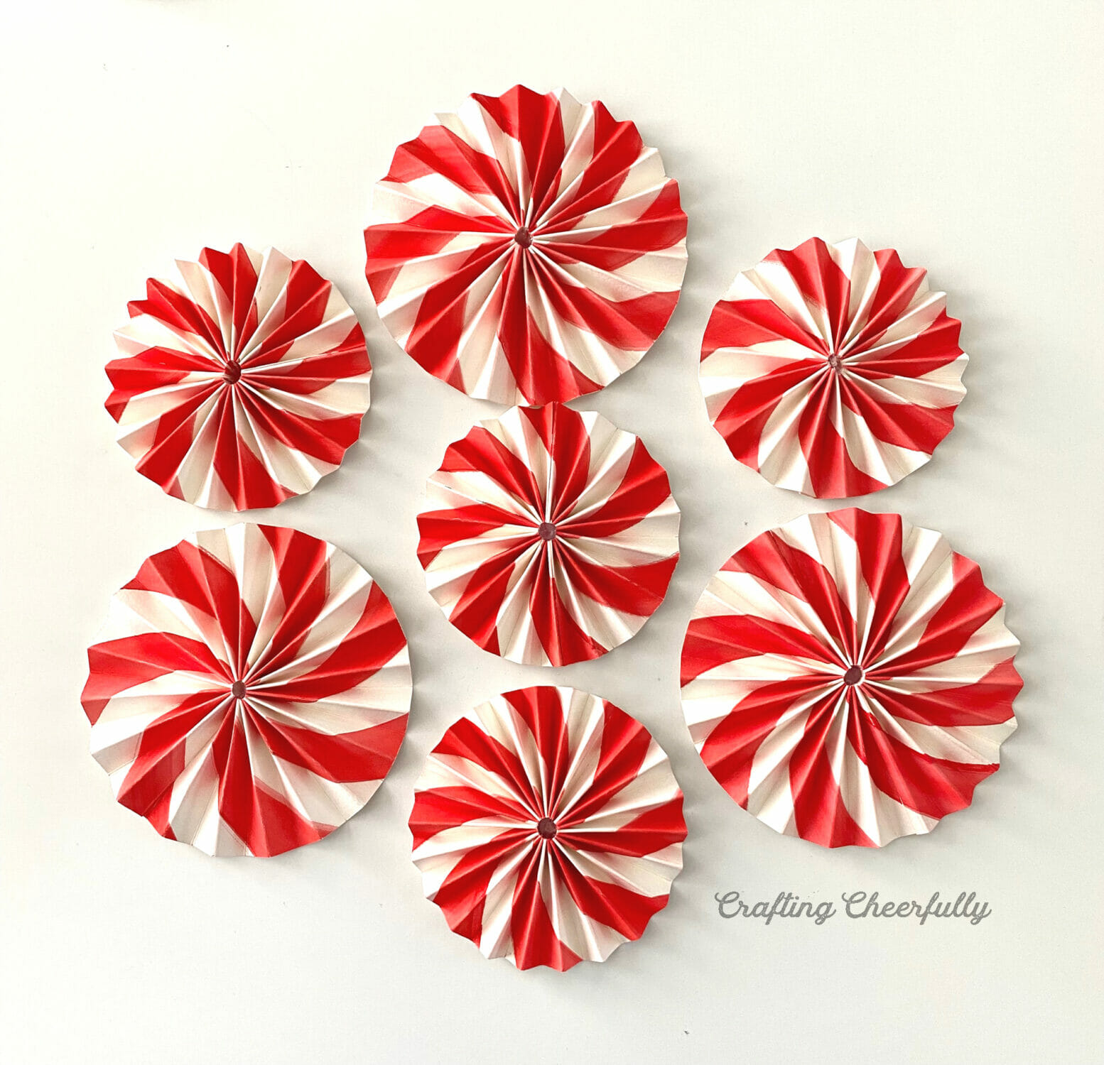 Peppermint paper medallions lay on a white table.