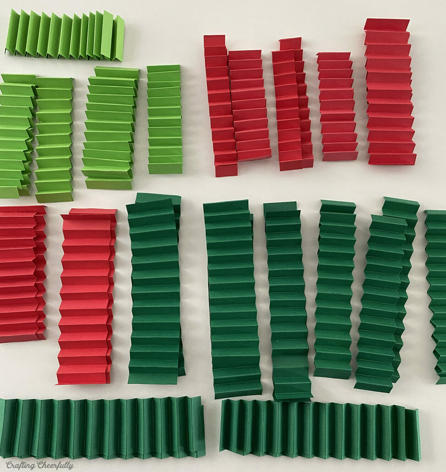Strips of accordion folded red and green paper.