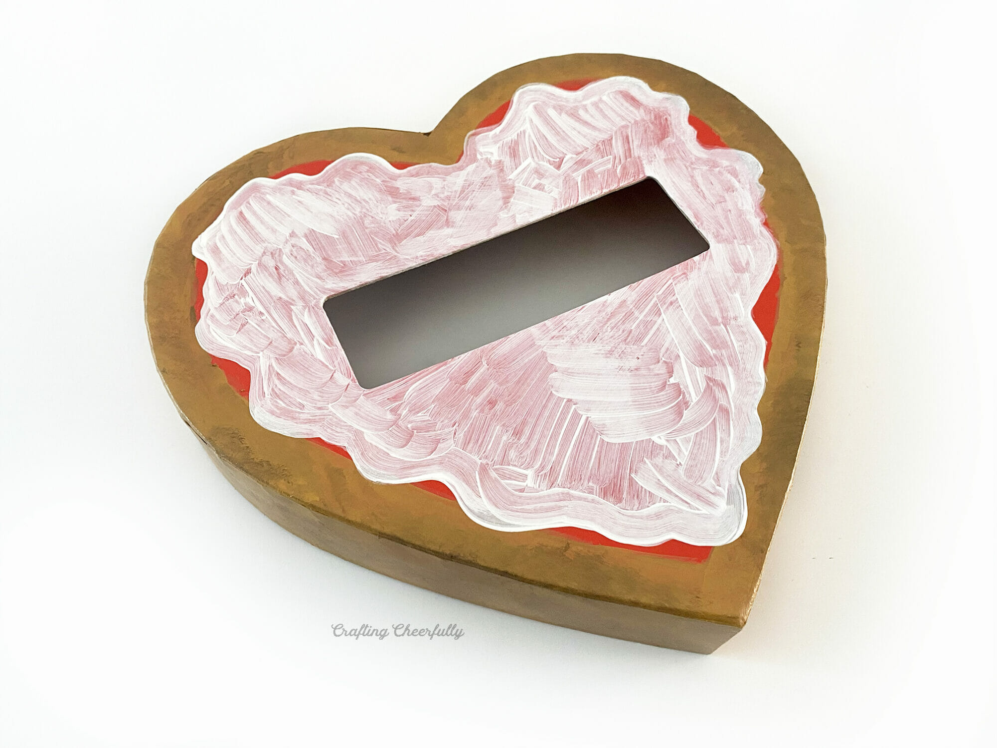 Cheese is painted on the top of the lid using white paint; the edges are curvy and inconsistent to look like cheese.