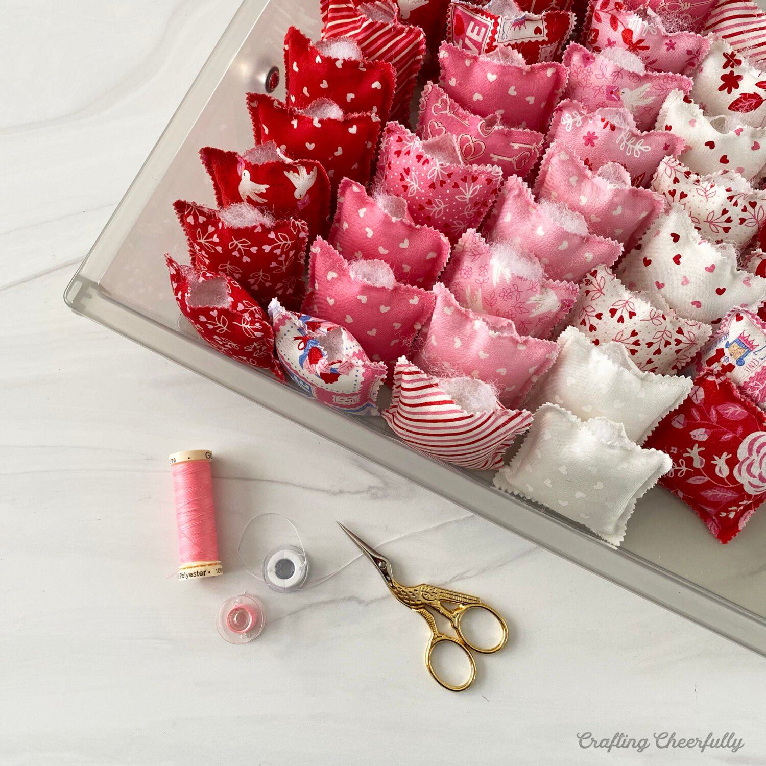 Small Valentine's Day pillows in a bin. 