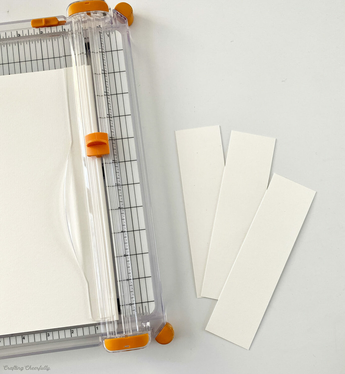 White watercolor paper cut using a paper trimmer into the shape of a bookmark. 
