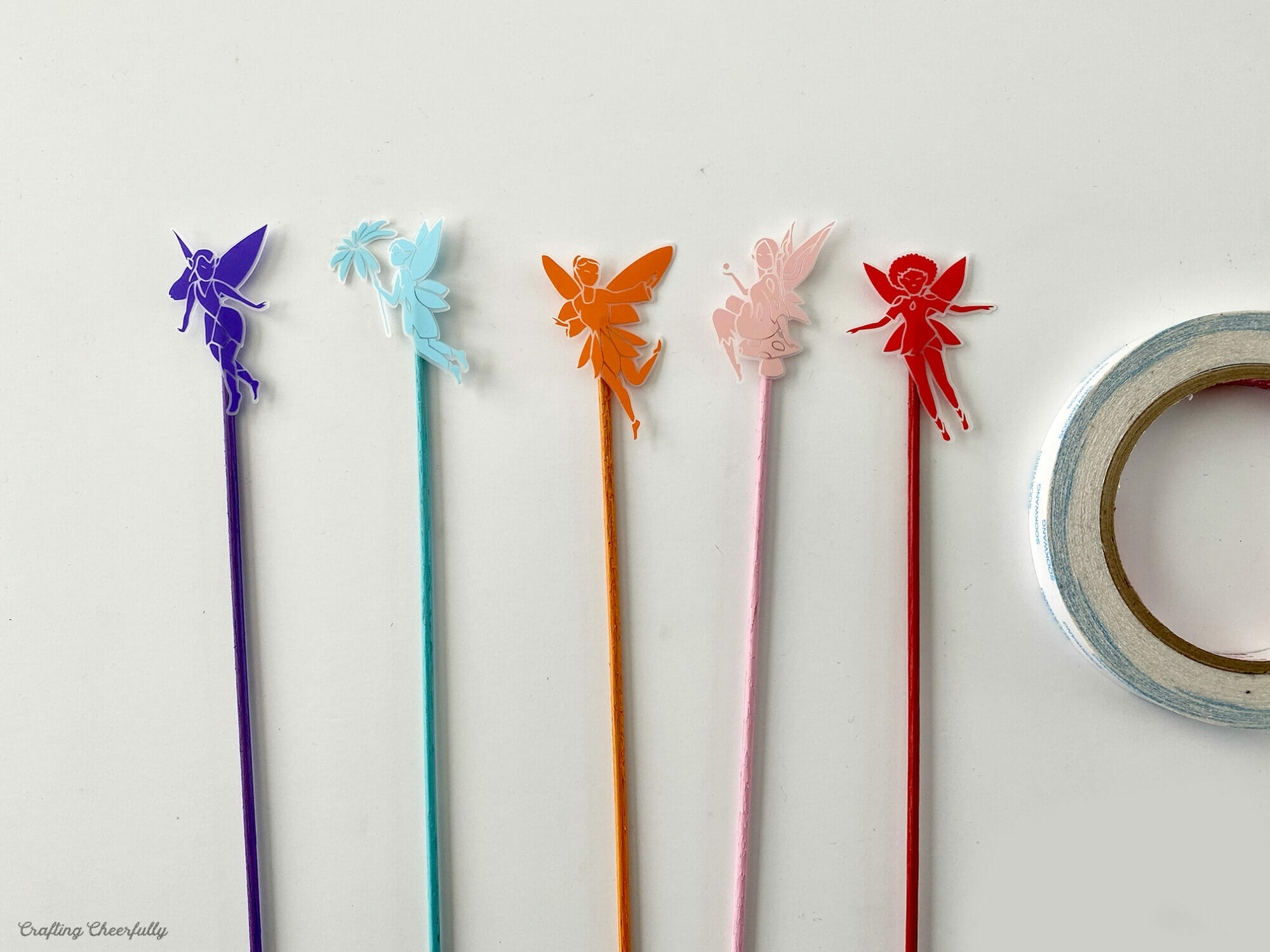 Five colorful fairy plant stakes.