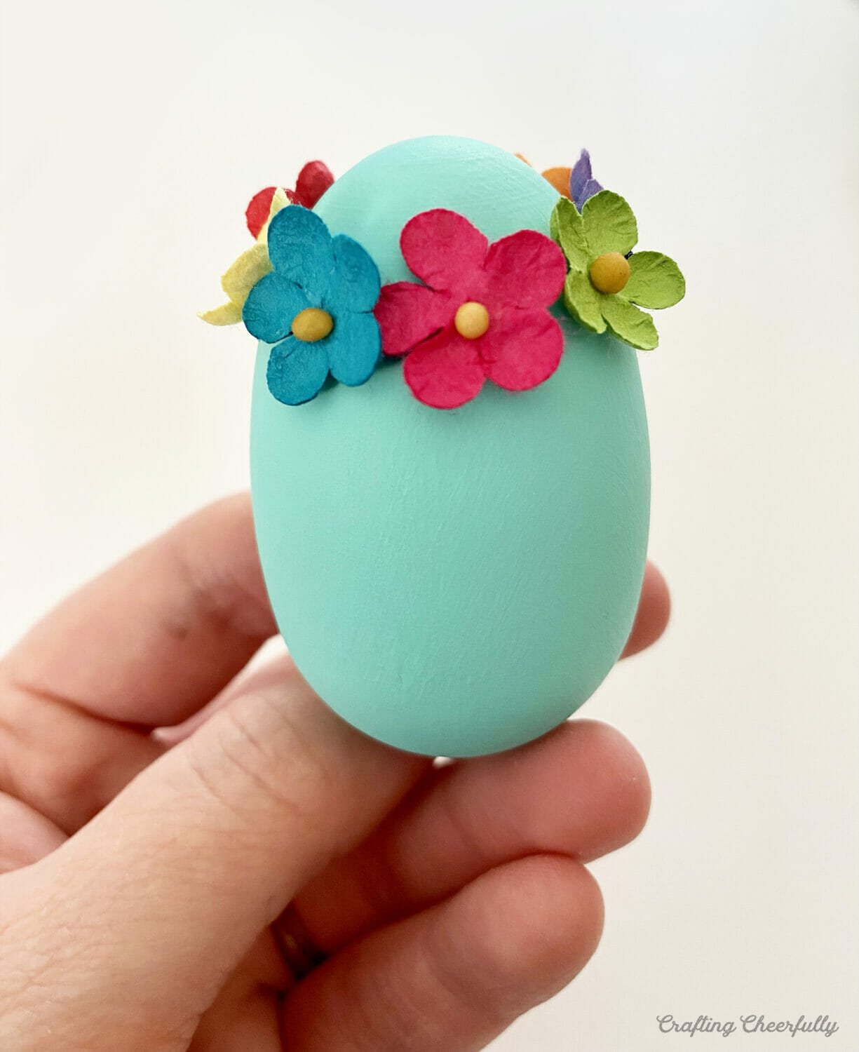 Teal Easter egg with cute flower headband.