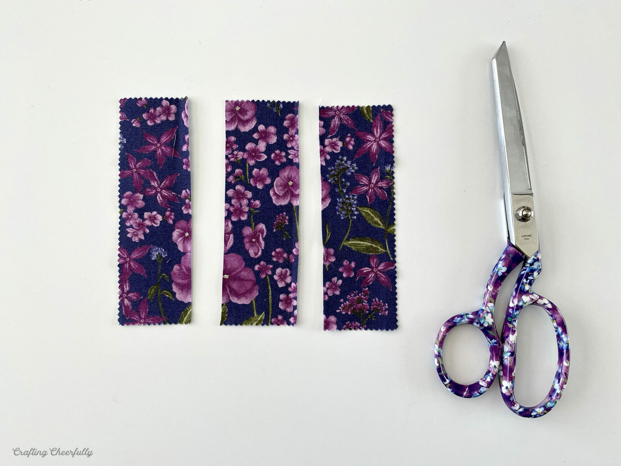 Charm pack piece of fabric cut into three pieces.
