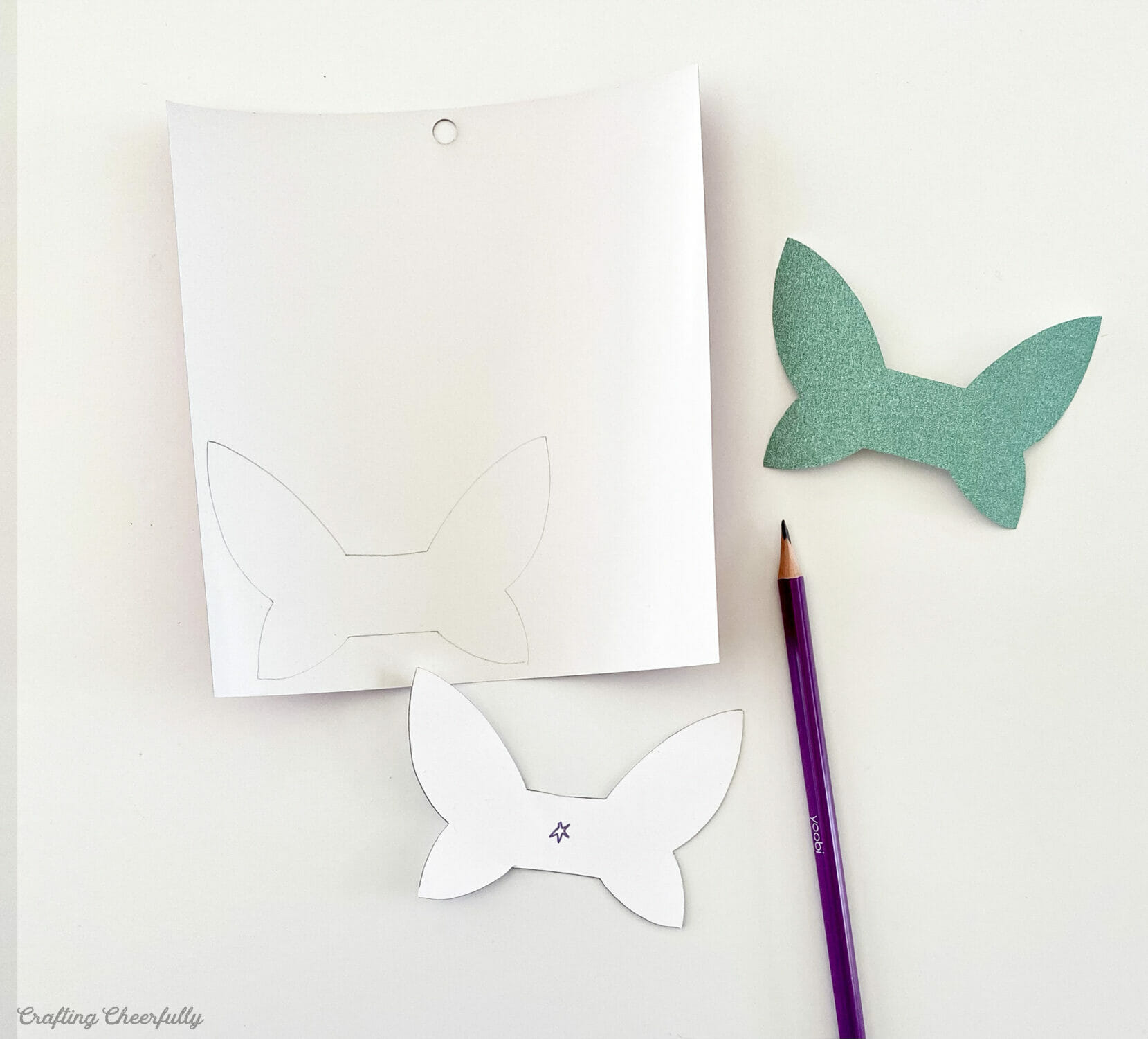 Wing template drawn on glitter paper.