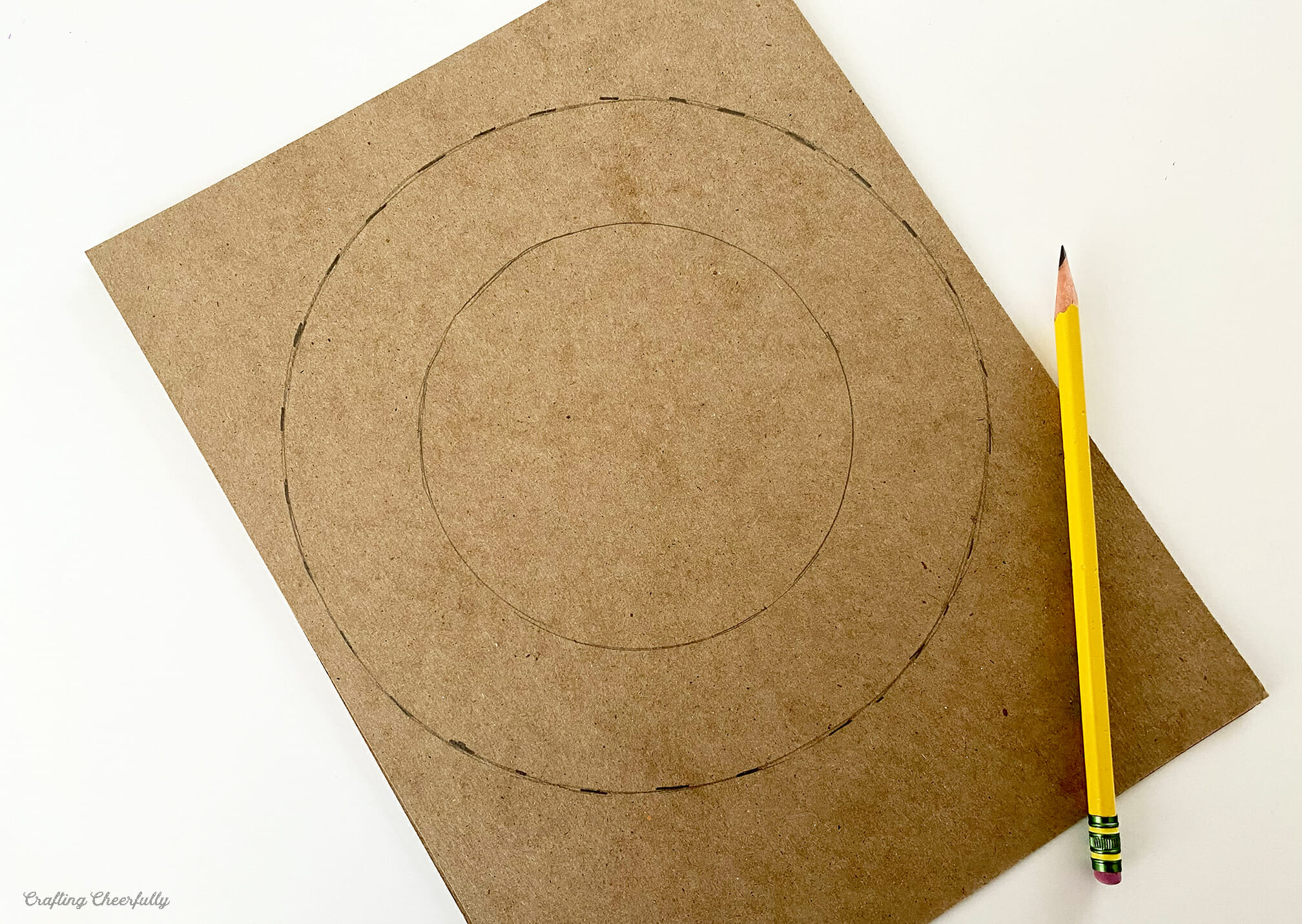 Two circles drawn on chipboard.