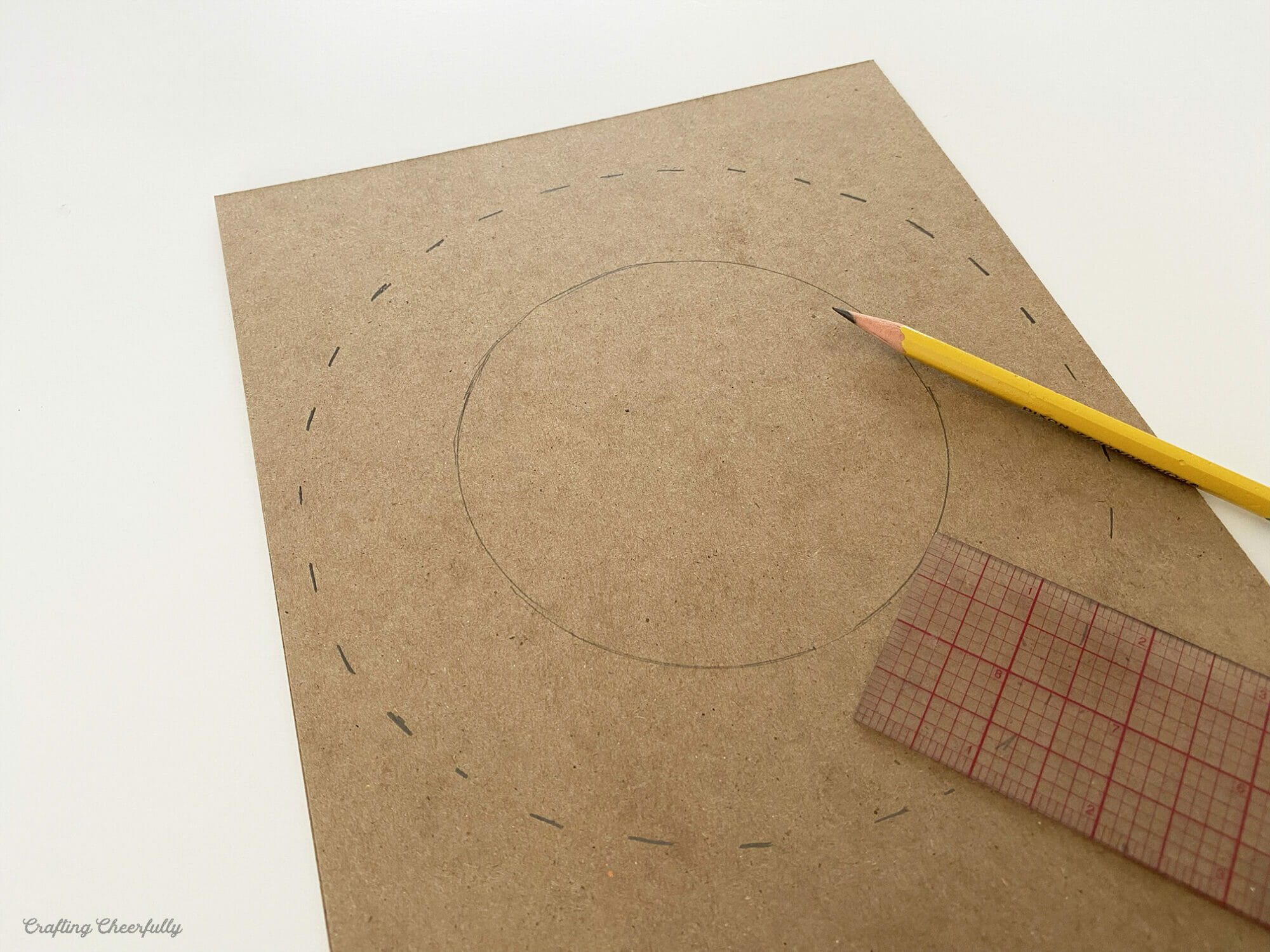 A second circle is drawn around the first using a ruler and pencil.