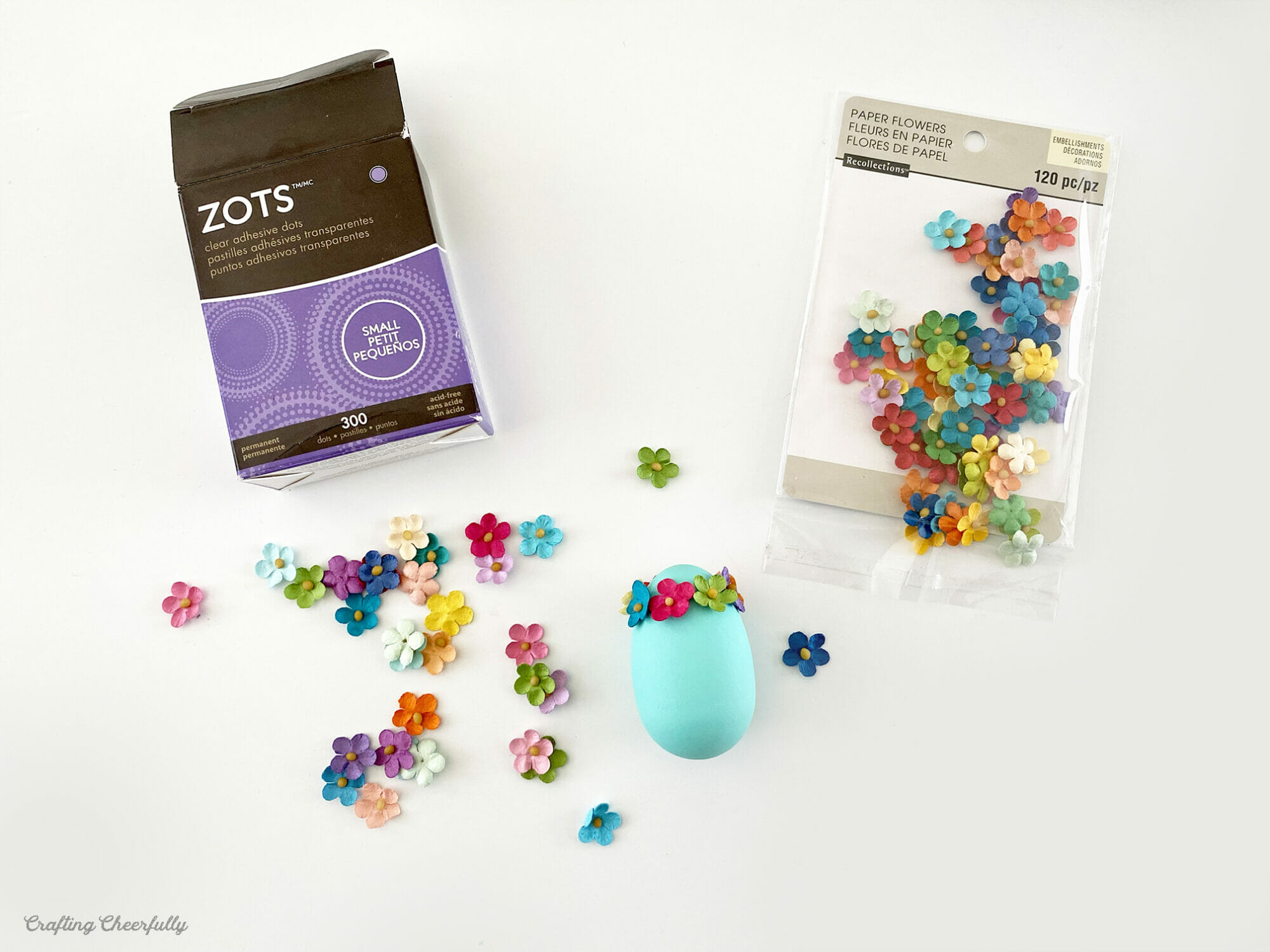 Tiny paper flowers are attached around the top of the egg using Zots glue dots.