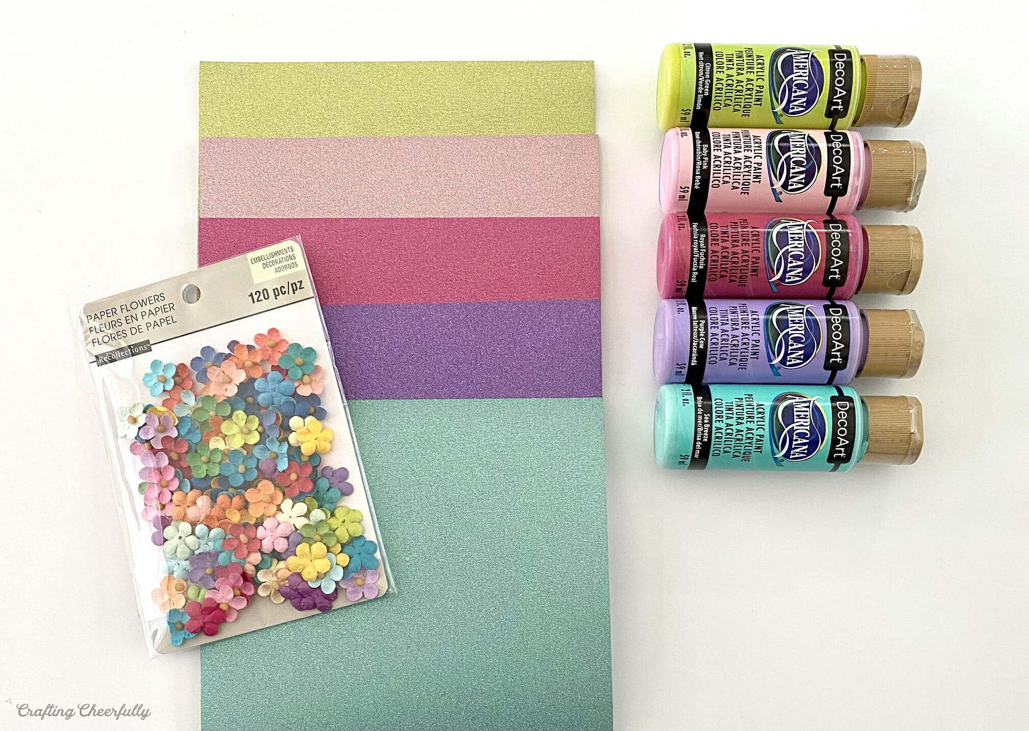Glittery paper, acrylic paint and paper flowers.