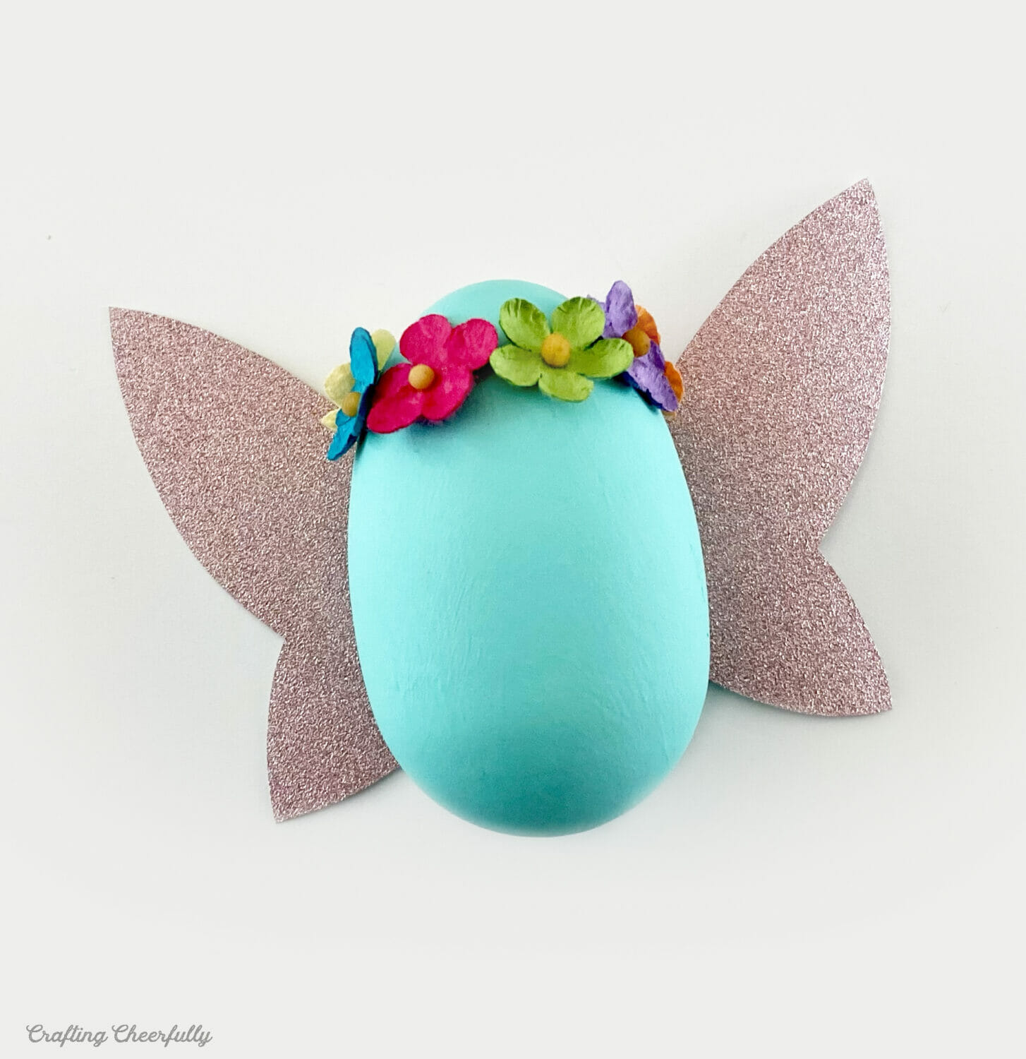 Sweet fairy egg is teal with pink glittery wings.