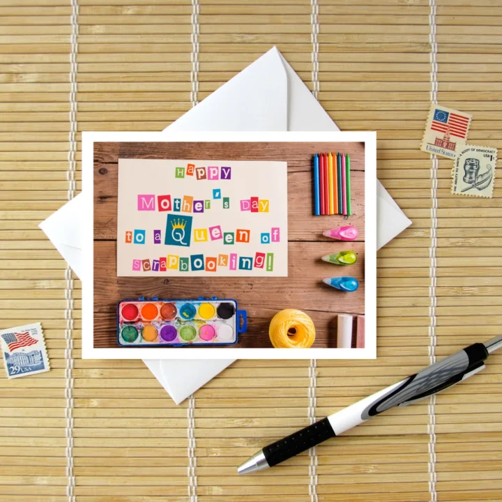 Notecard with photographed scrapbooking supplies; the words 'Happy Mother's Day to a Queen of Scrapbooking' are created from cut out letters.