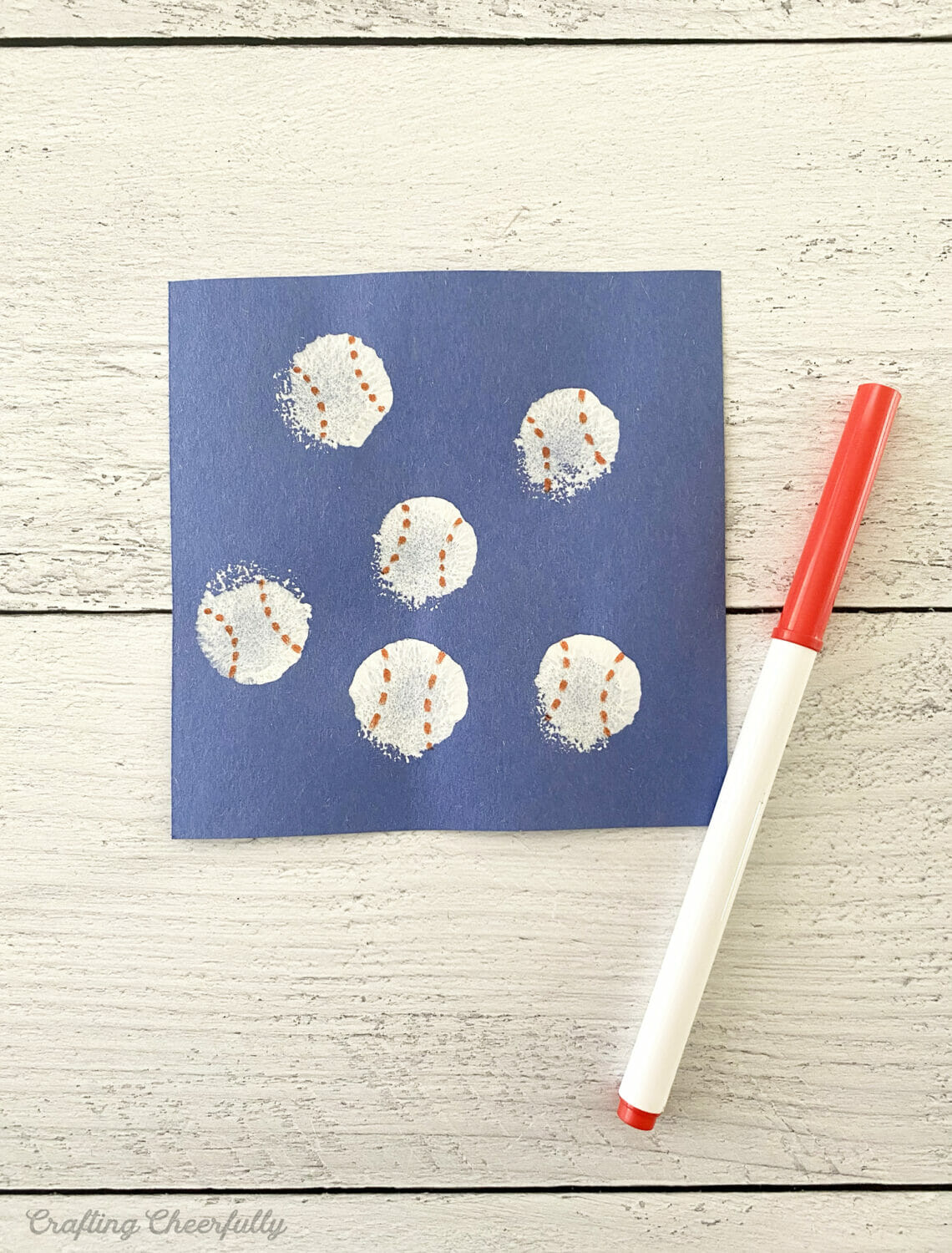 Red marker is added to white circles of paint to create baseballs.