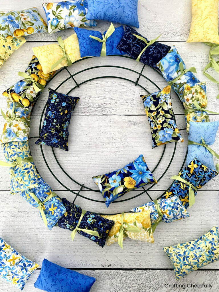 Pillows are organized on a wire wreath frame.