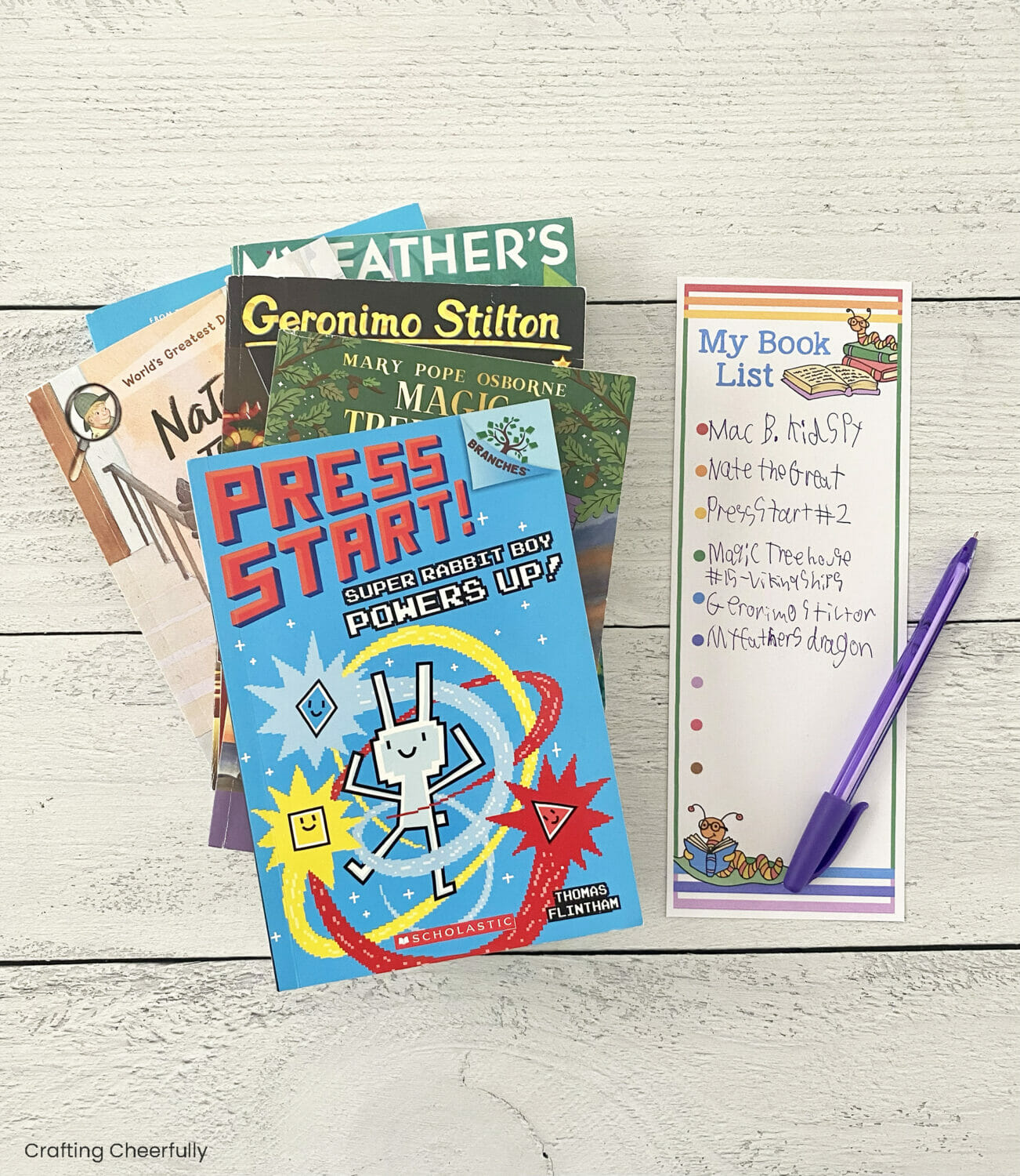Stack of children's chapter books sit next to a reading book list.
