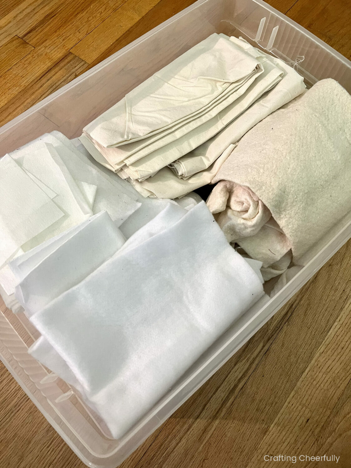 Interfacing, batting and muslin sorted in a storage bin.
