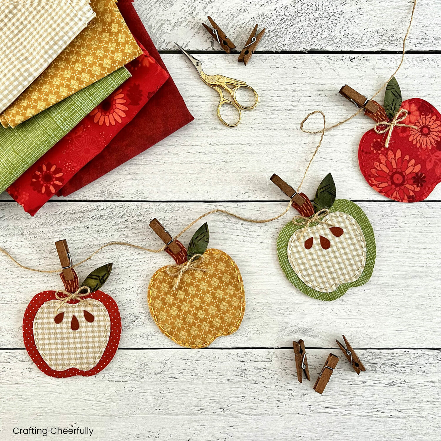 Fabric apple banner strung together using twine and mini clothespins.