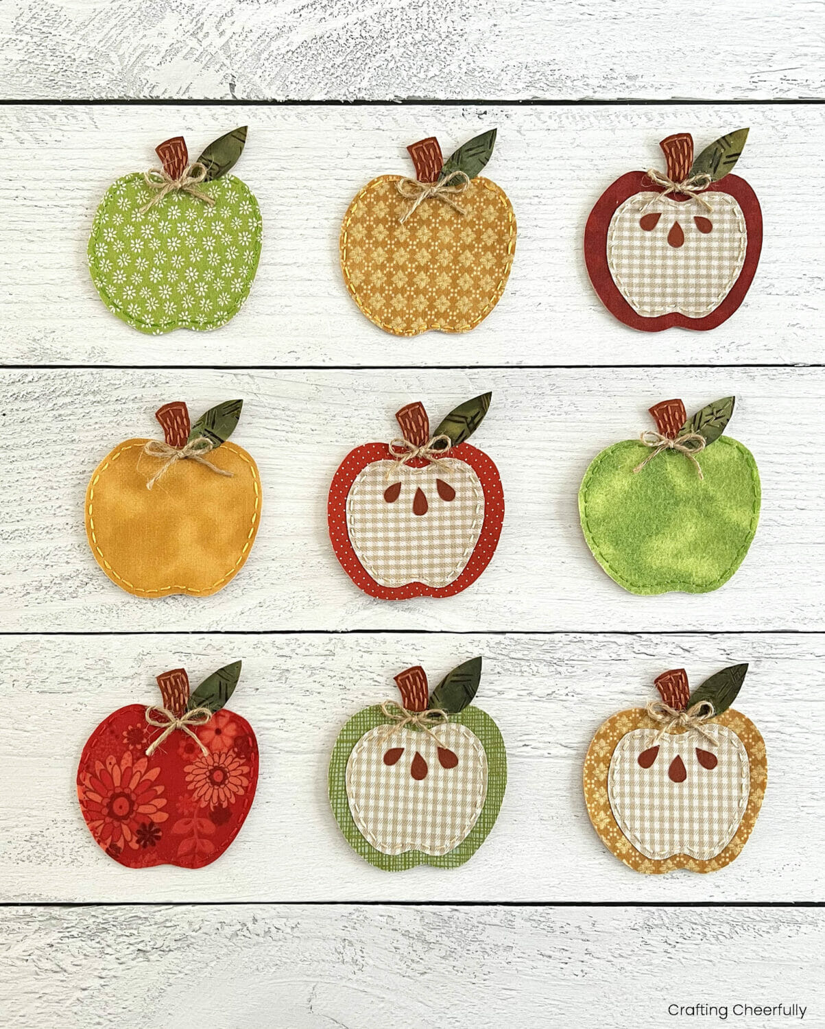 Apple pennants are arranged on a white wooden table.