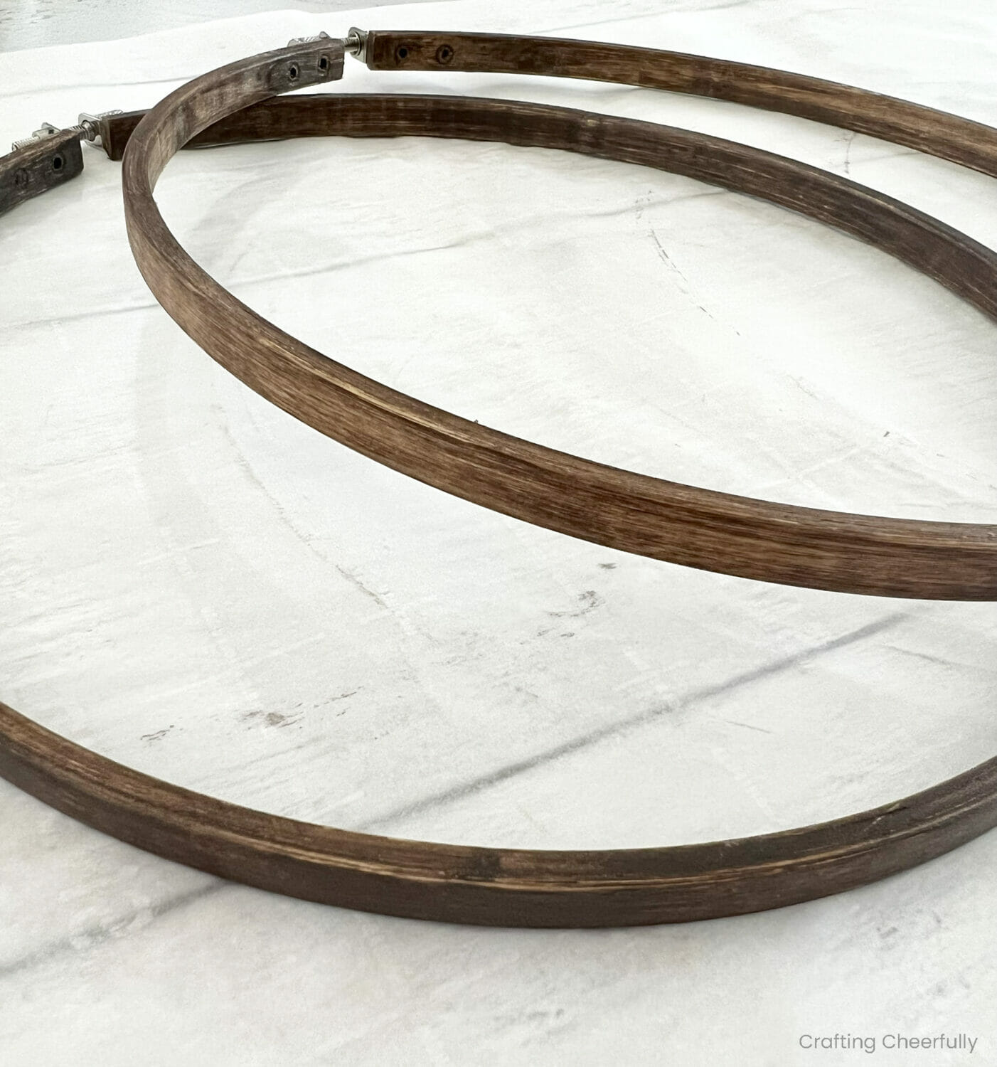 Two hoops that have been stained a walnut color.