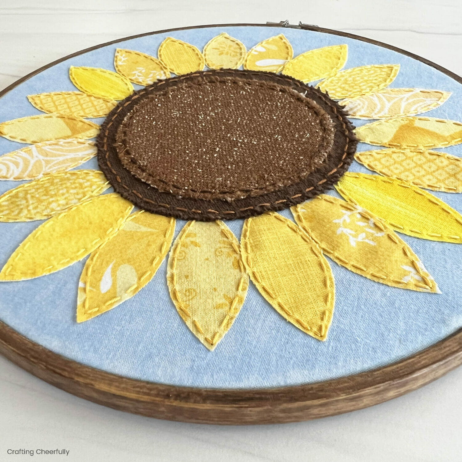 Sunflower embroidery hoop made from fabric scraps.