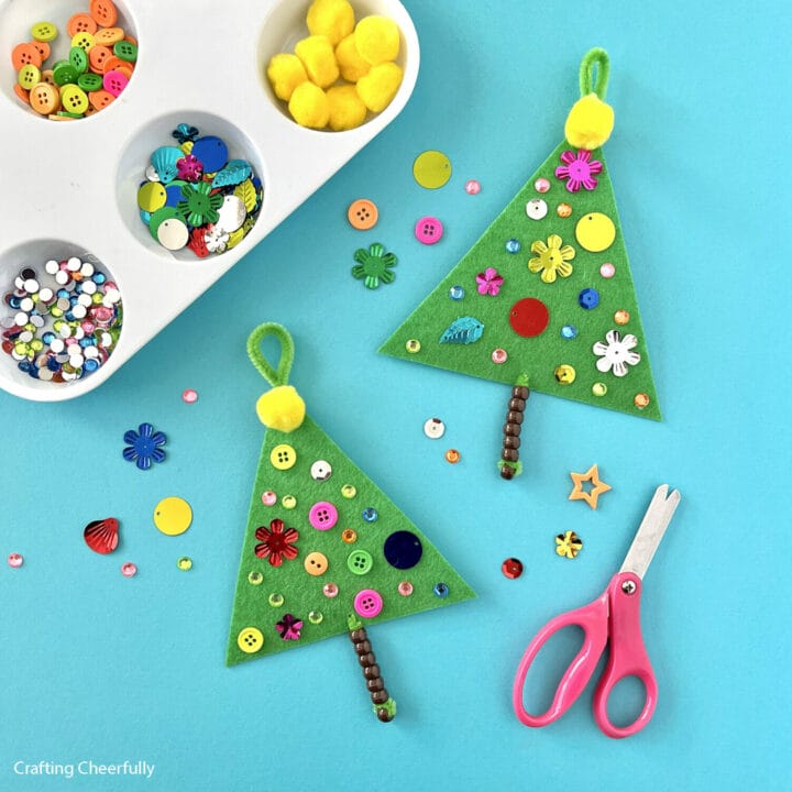 Two handmade Christmas tree kids crafts made from felt, pipe cleaners, beads and buttons.