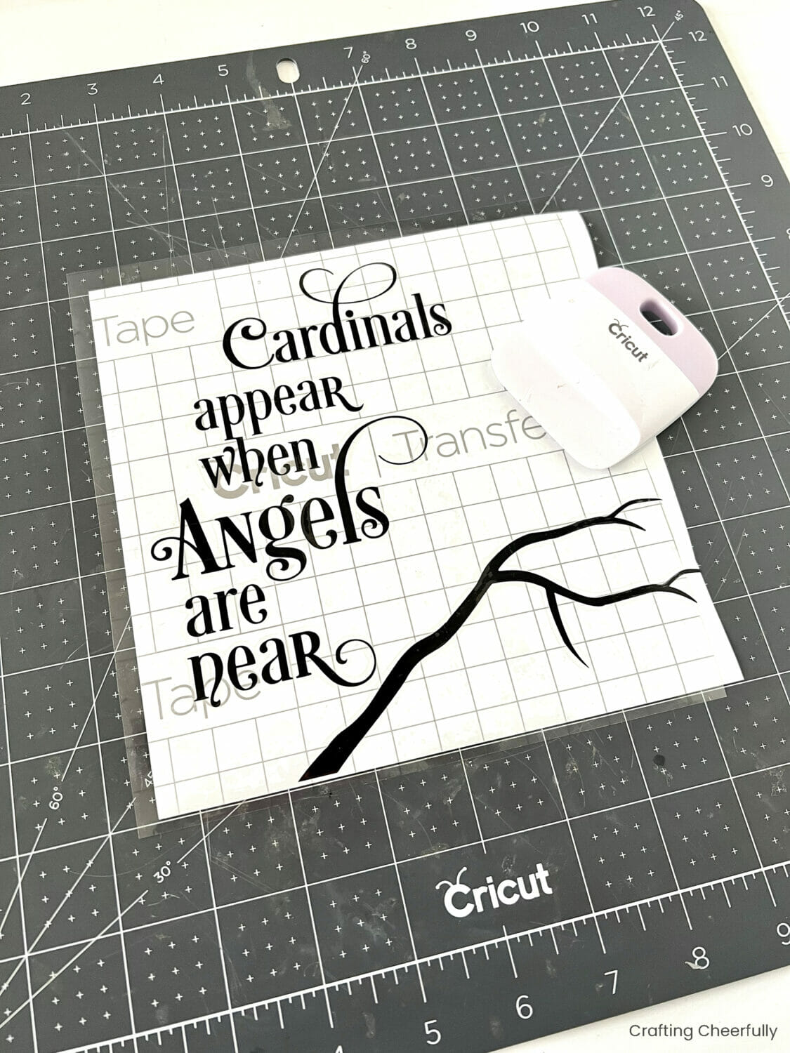 A piece of transfer tape is applied to the vinyl design using a scraper.