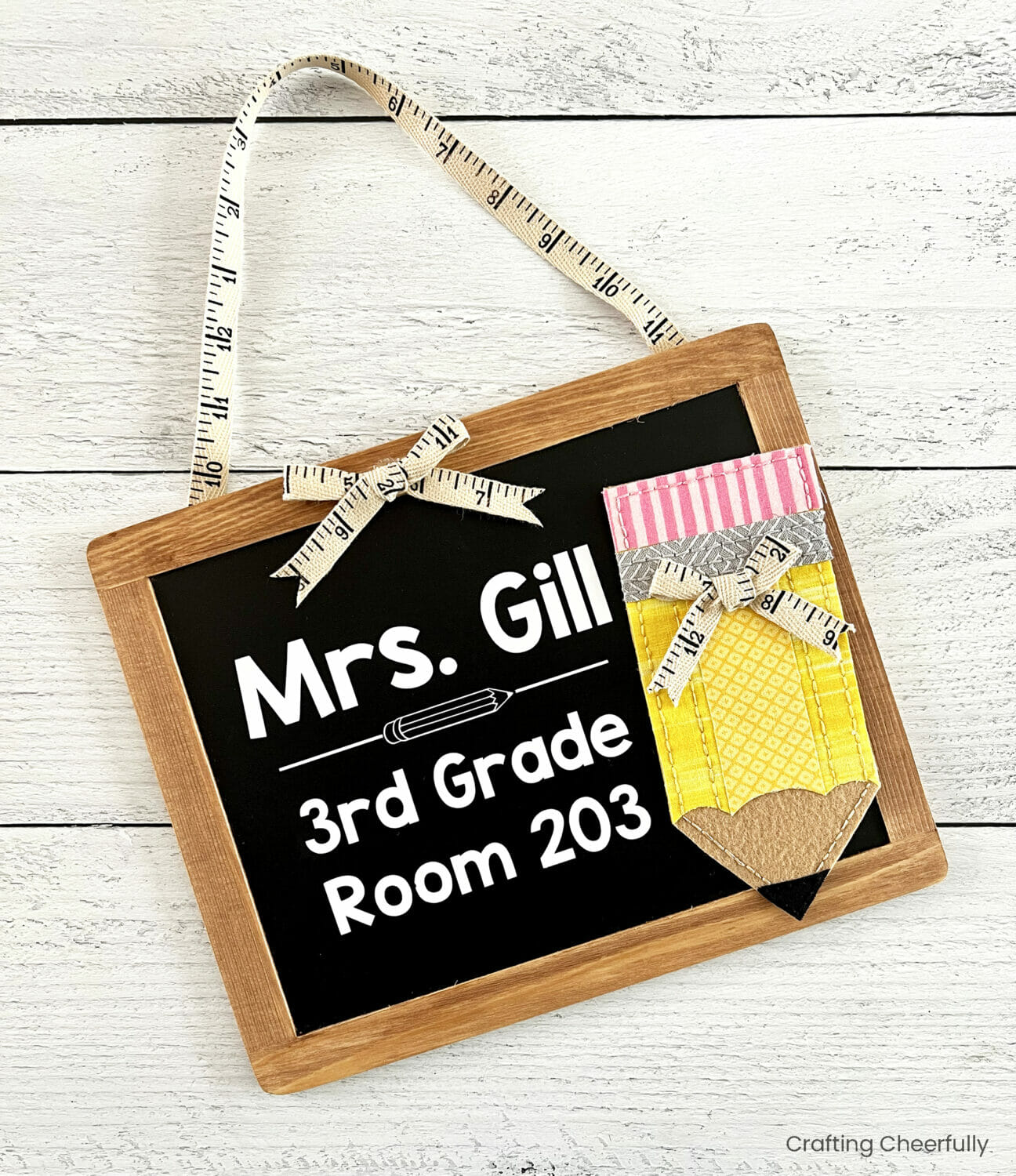 Chalkboard sign reads Mrs. Gill, 3rd grade room 203; a fabric pencil decorates the side.