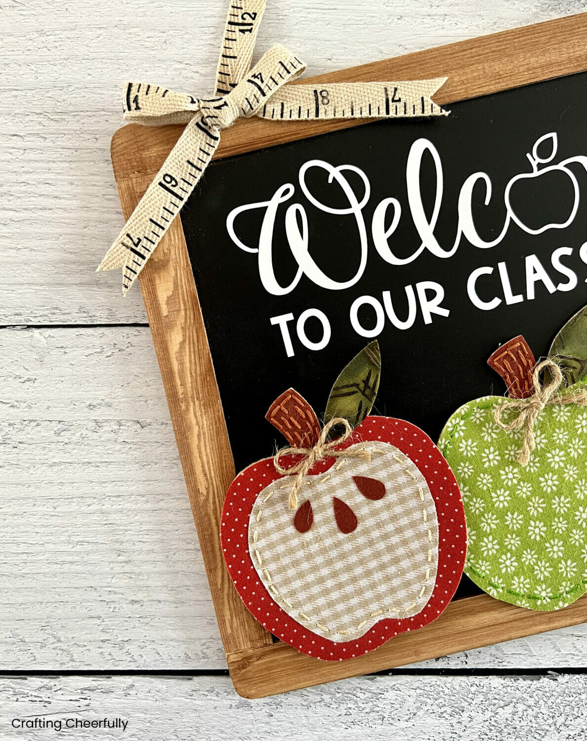 A cute bow made from ribbon that looks like a ruler at the top corner of the chalkboard sign.