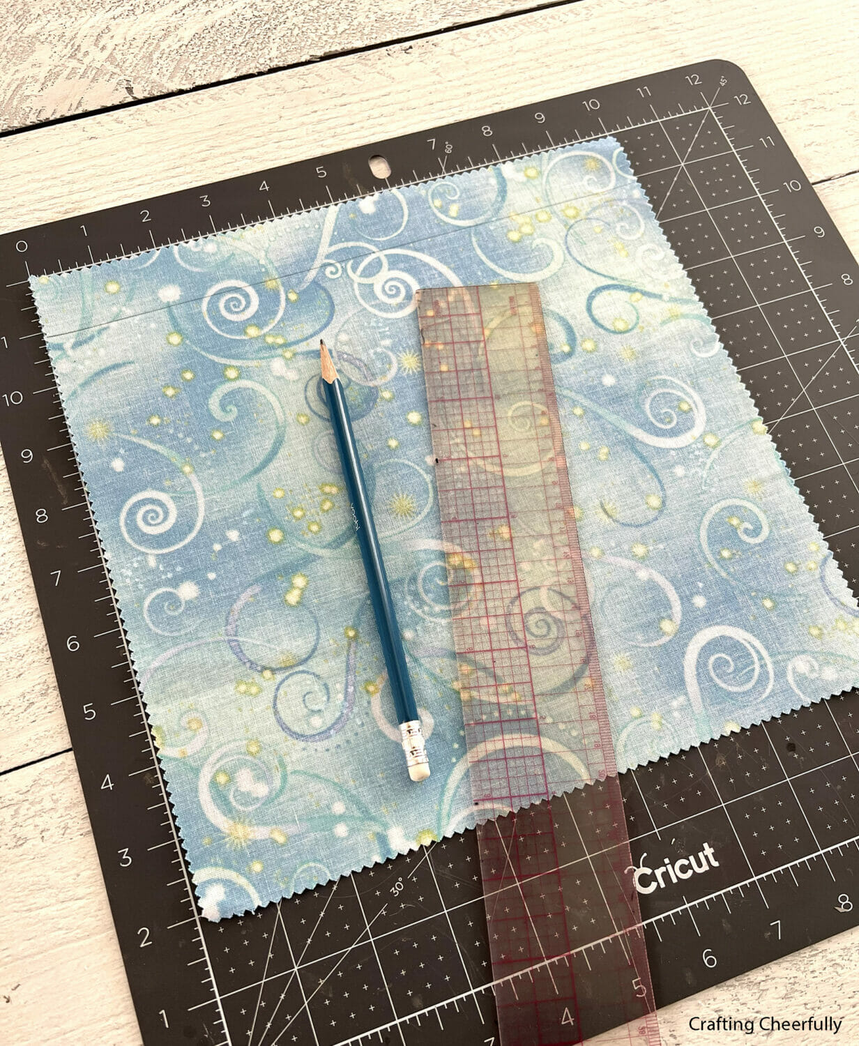 A ruler is used to mark a piece of fabric.
