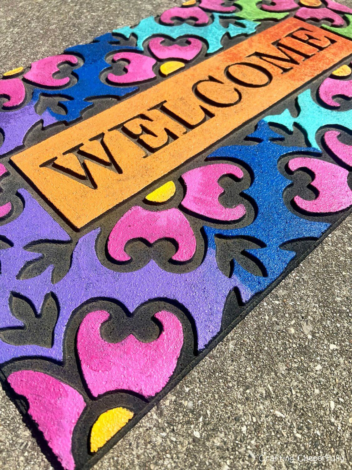 Welcome door mat painted with colorful acrylic paint.