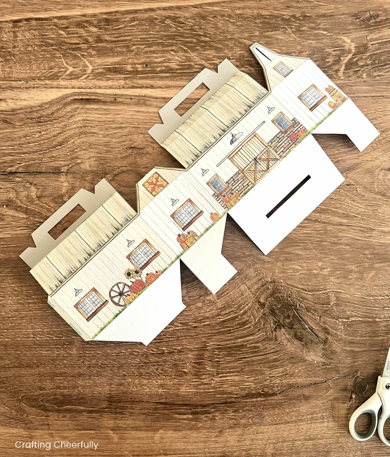 The two pieces of a fall barn treat box are adhered together along one tab.