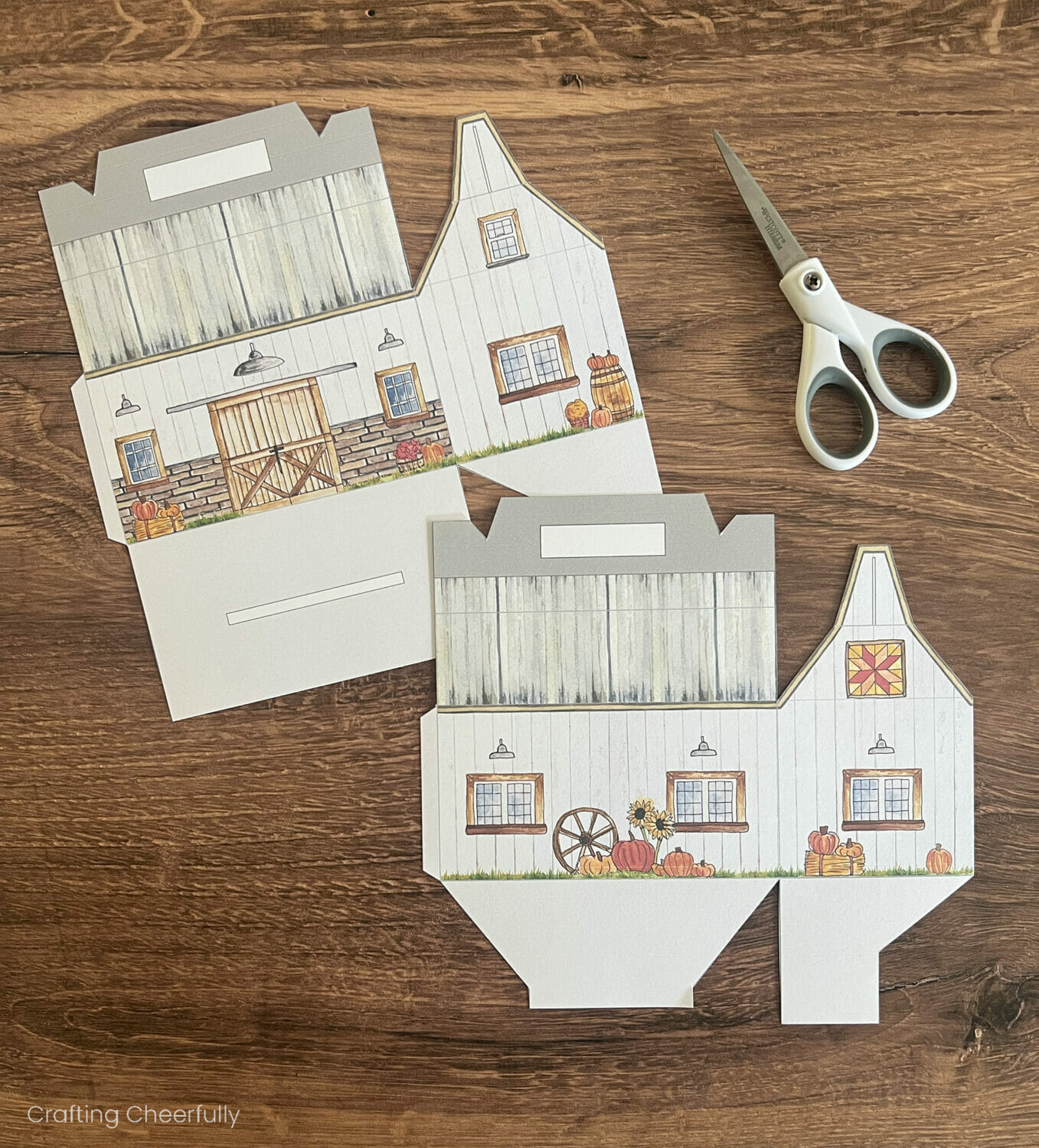 Two pieces of the barn treat box are cut out with a scissors.