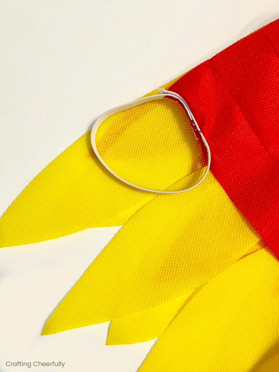 A loo of elastic is sewn to the end of the wings where it can attach to a child's wrist.