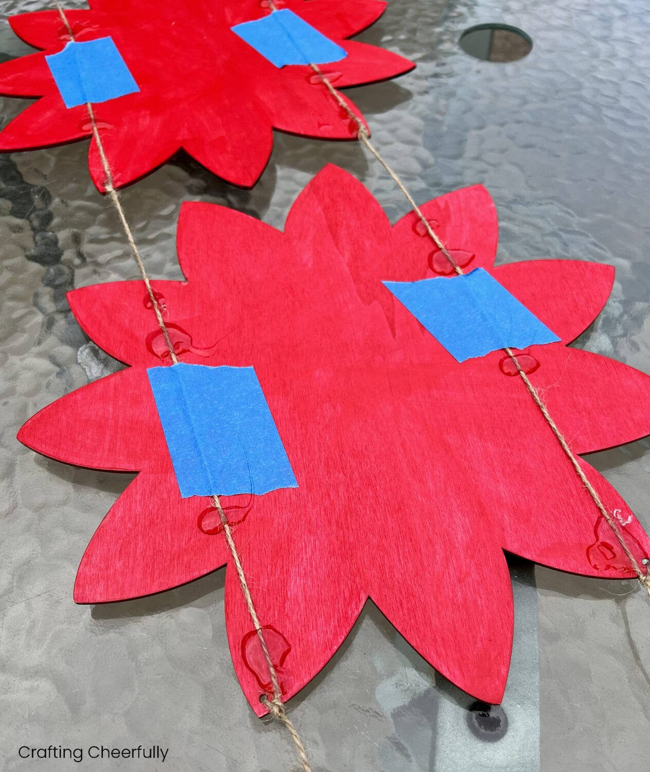 Twine is glued to the back of the wooden poinsettias.