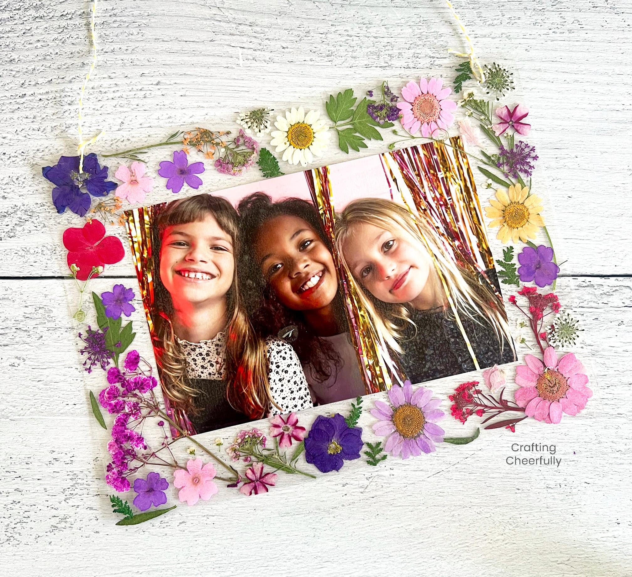 Floral frame with hanging string.