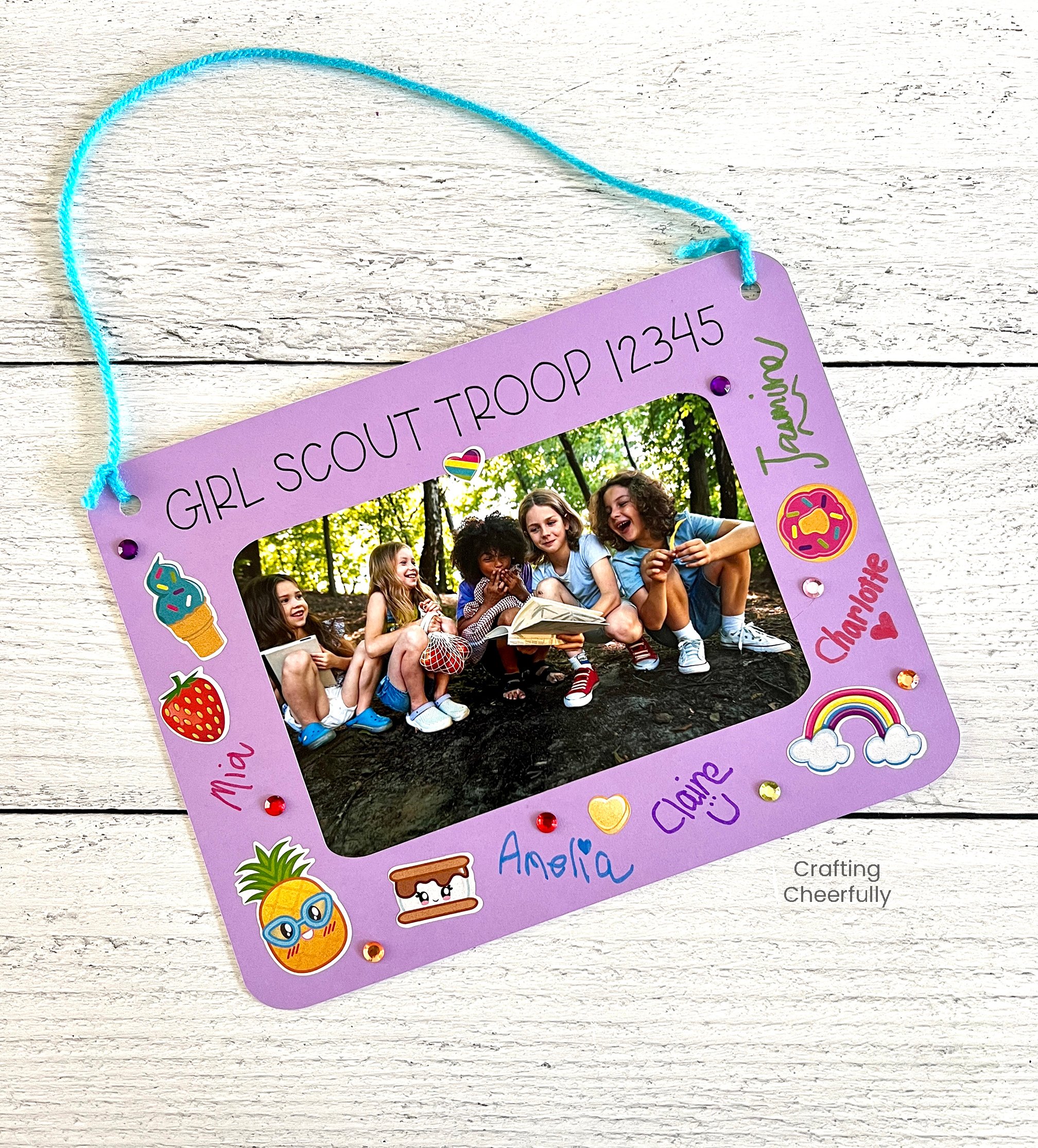 Purple frame for a girl scout troop keepsake is signed and decorated with stickers.