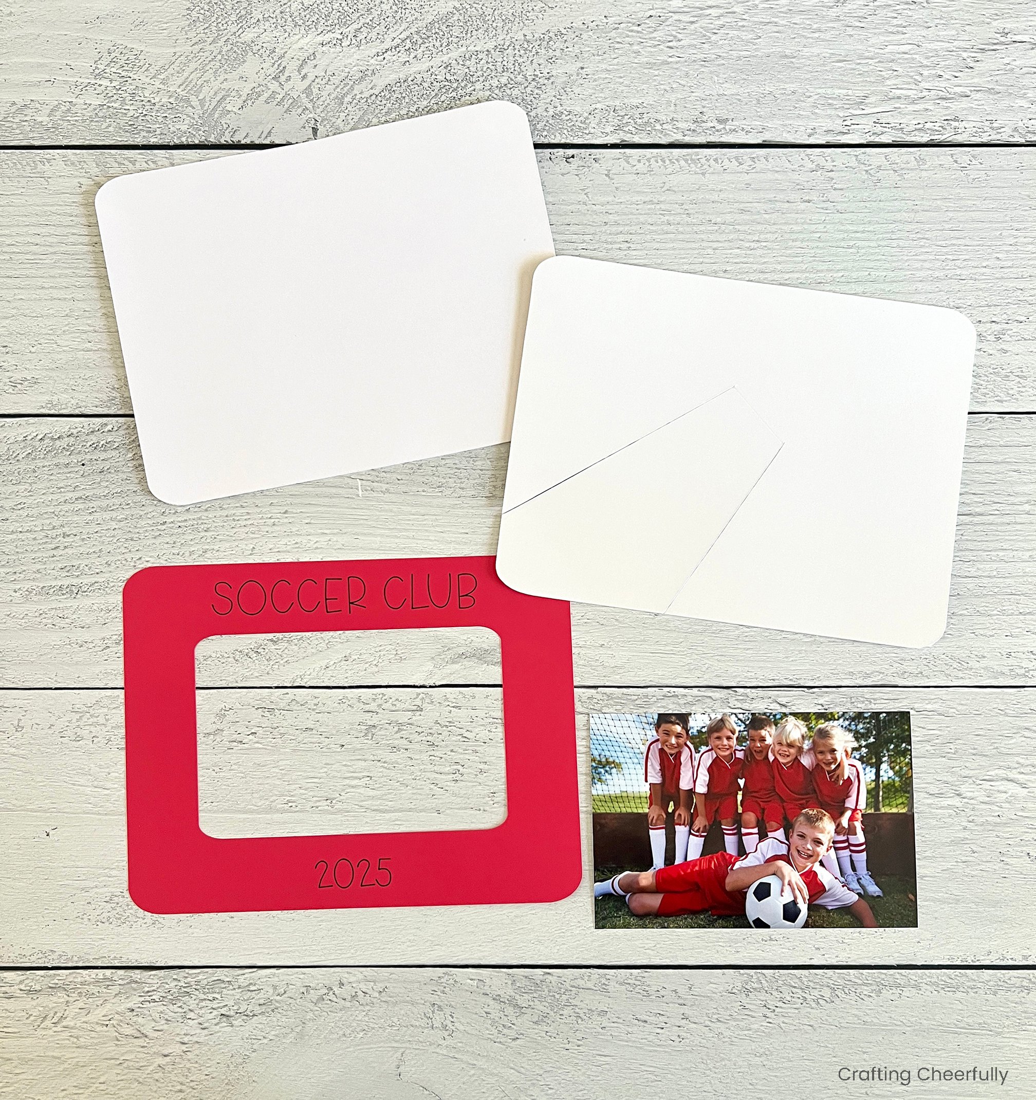 The frame pieces are cut out and lay next to a photo.