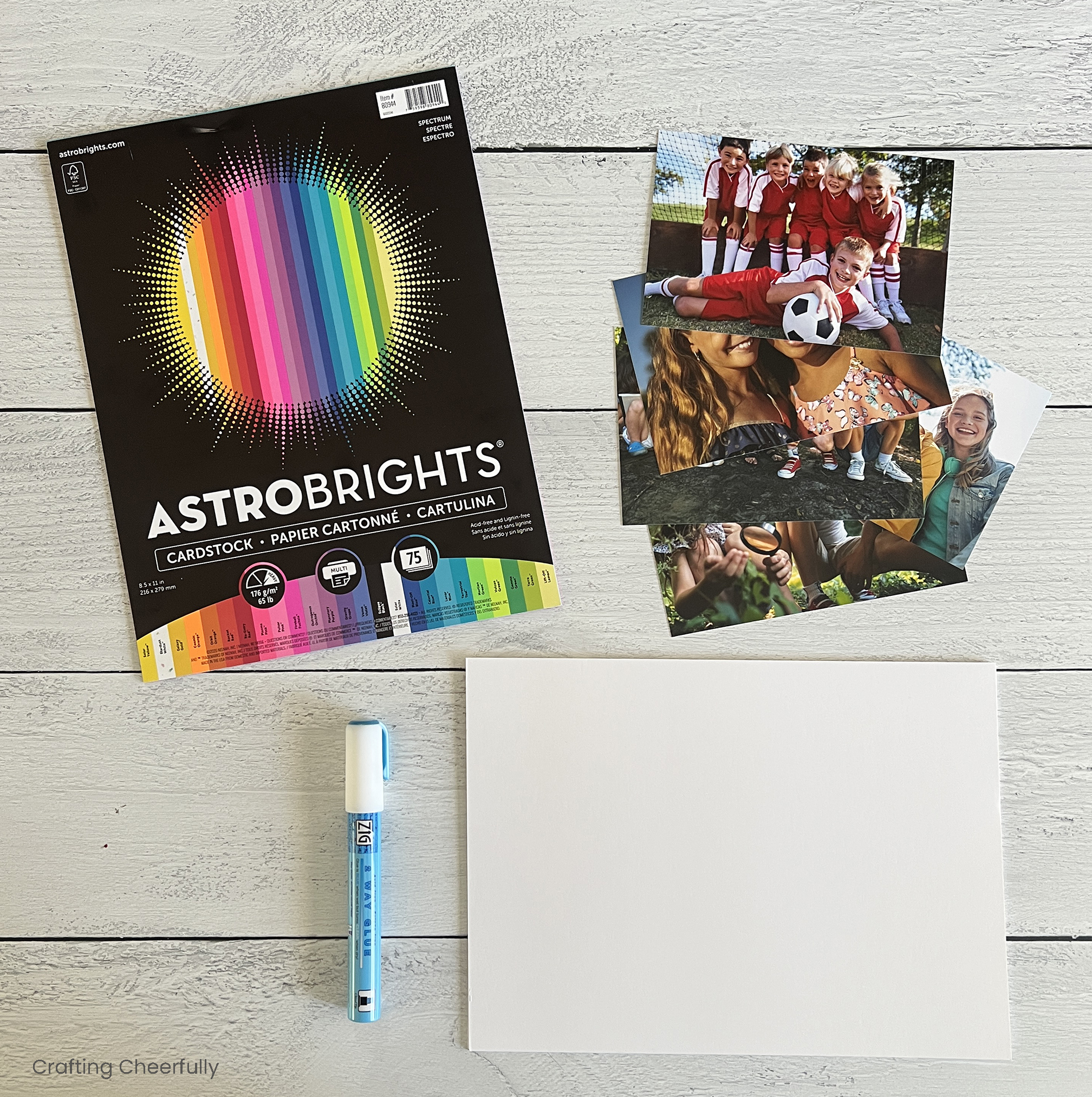 Supplies including colorful cardstock, photos, chipboard and a glue pen.