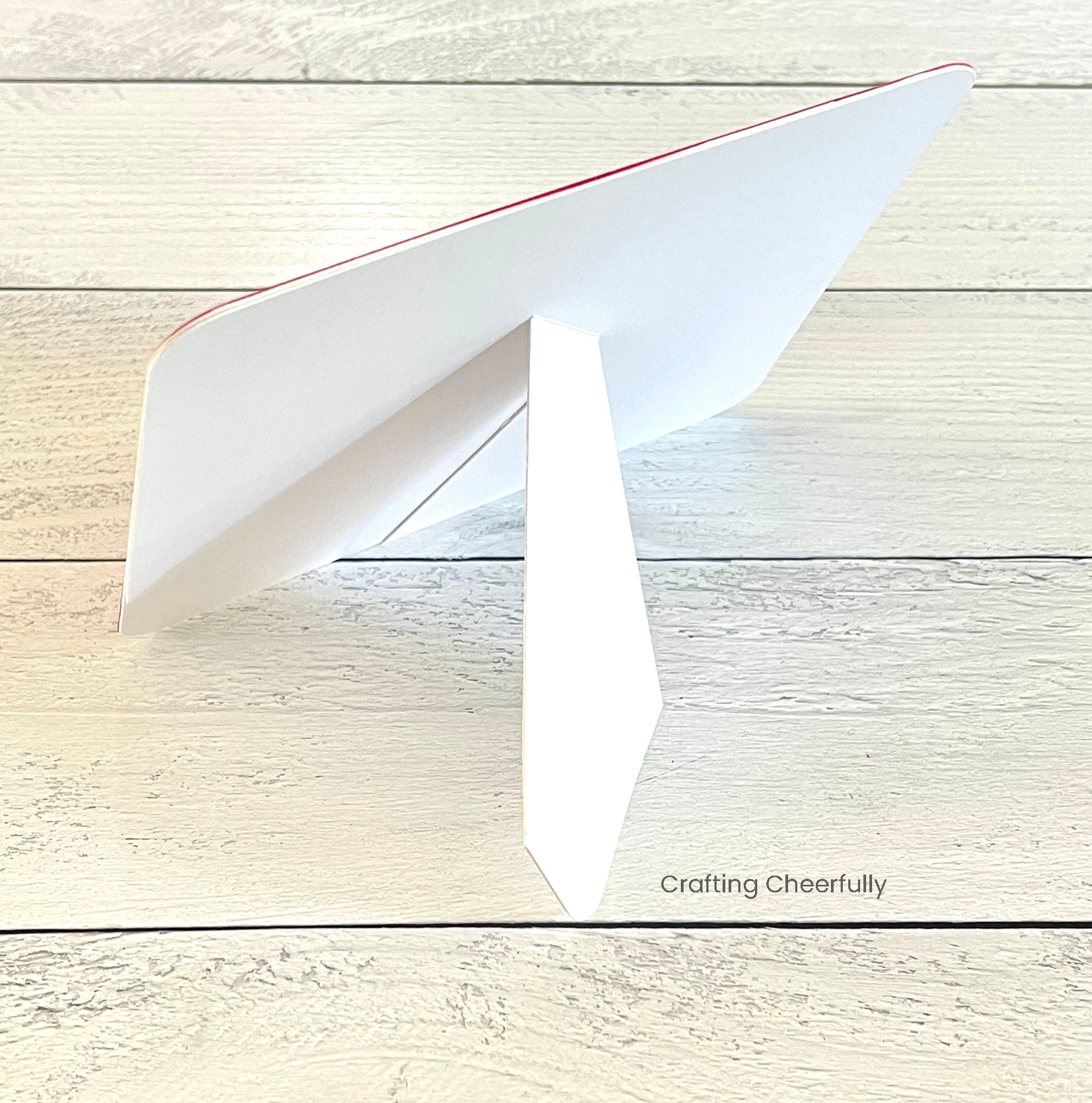 The cardstock frame is standing up using a kickstand.